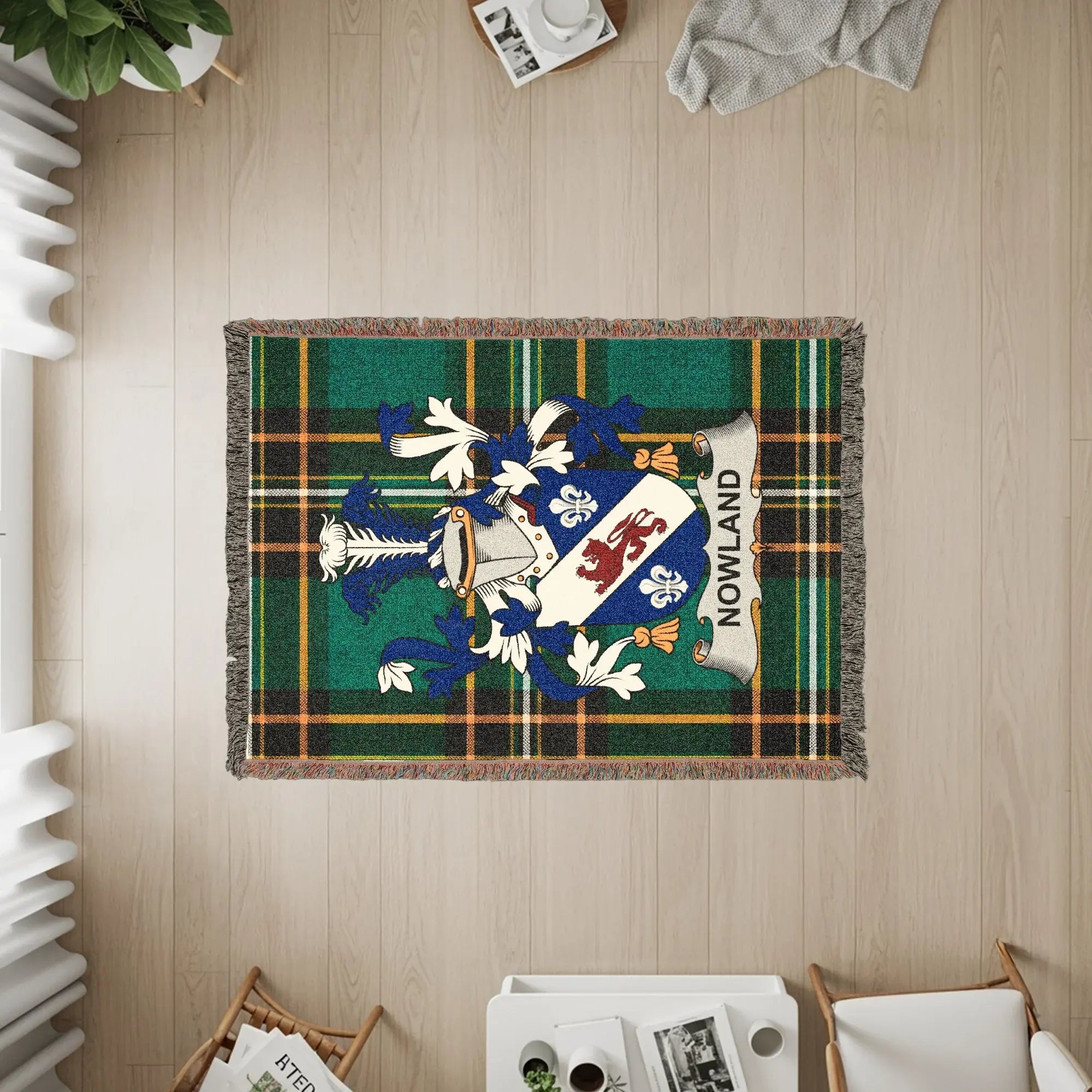 Woven blanket with the "Nowland" coat of arms displayed on a plaid background.