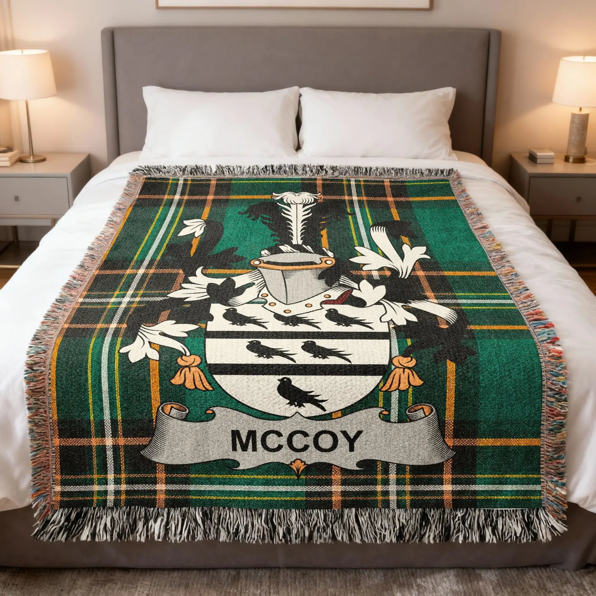 Green tartan blanket with McCoy family crest on a bed.