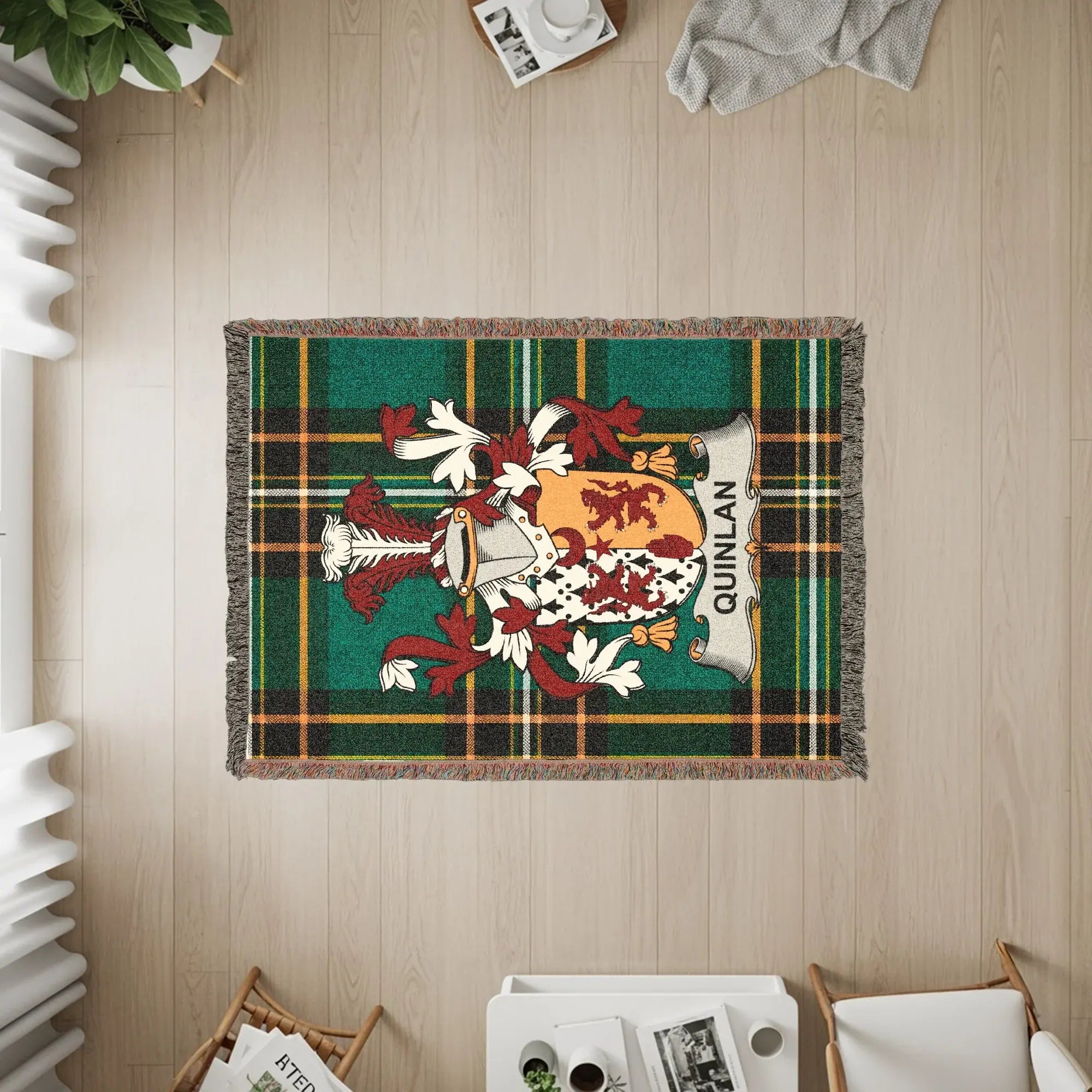 Tapestry throw with green plaid and the QUINLAN clan crest.