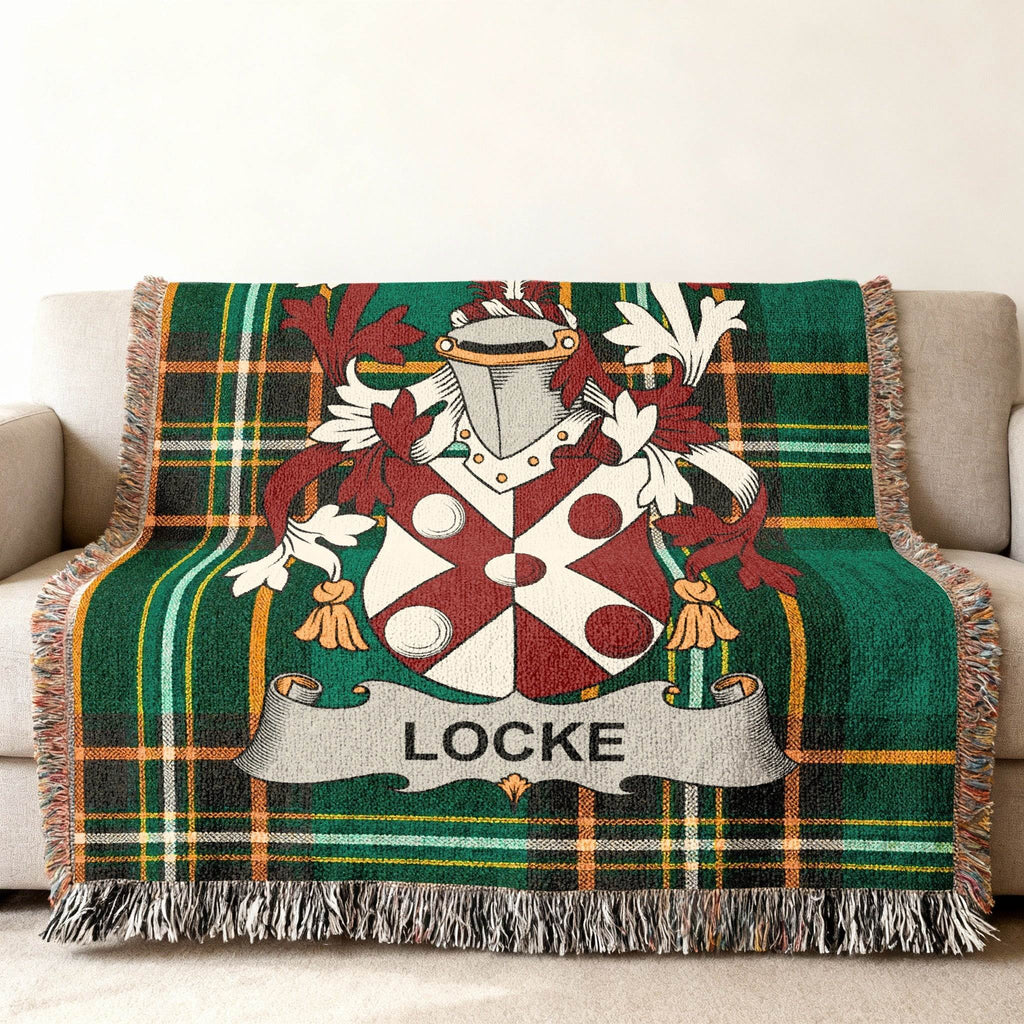 Tartan blanket with Locke family crest in green and red plaid.