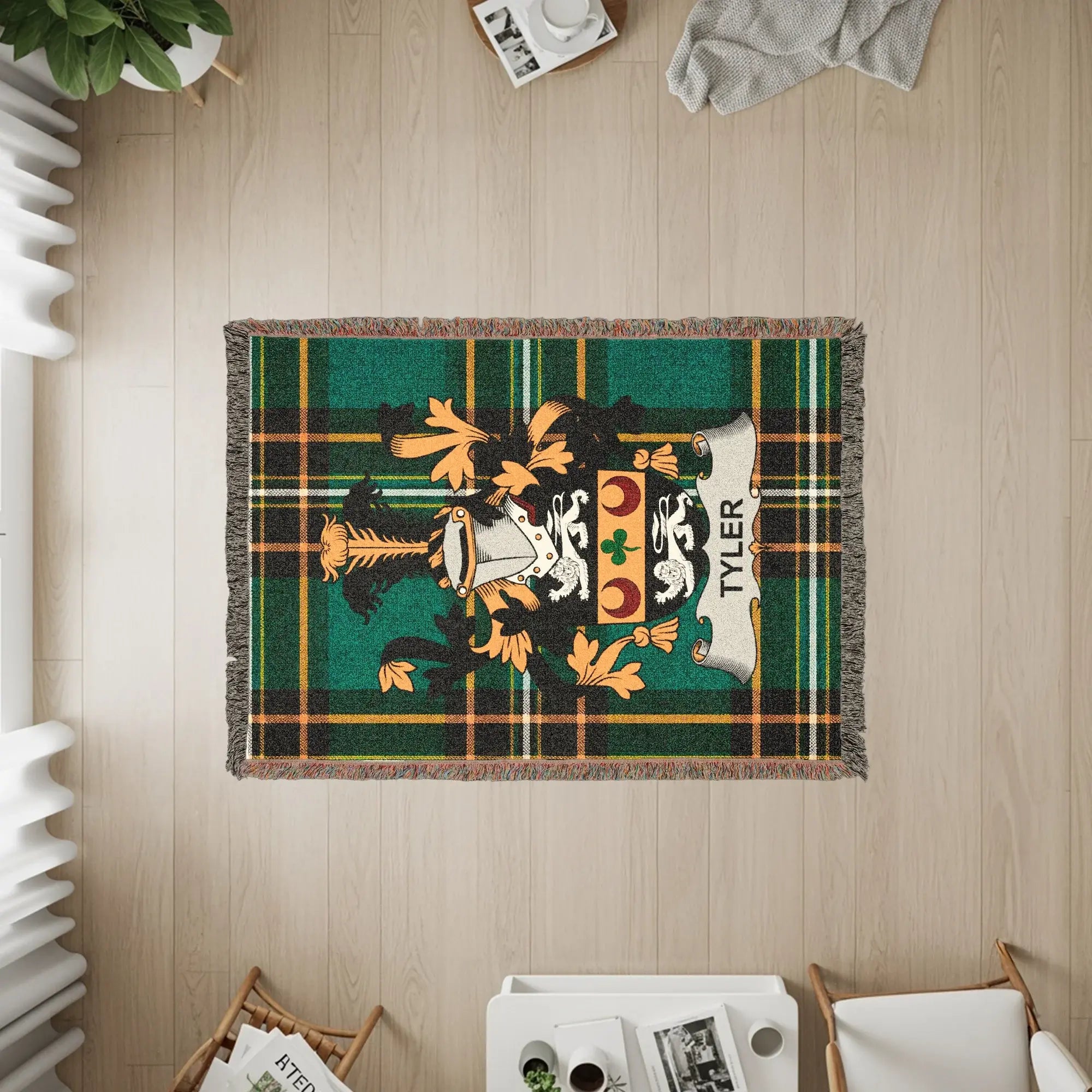 Woven throw blanket with a green plaid background and the Tyler family crest.
