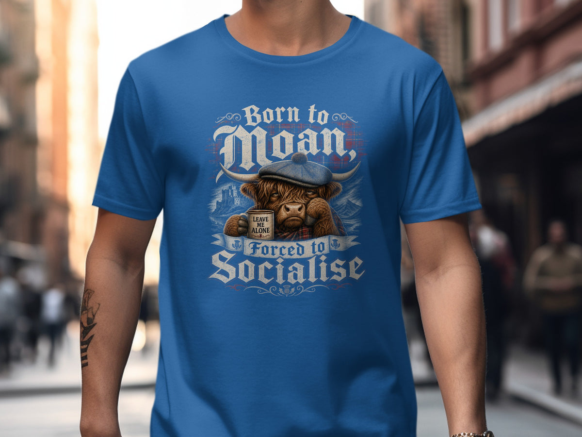Highland cow wearing cap holding mug that says "Leave me alone" with text "Born to Moan, Forced to Socialise".