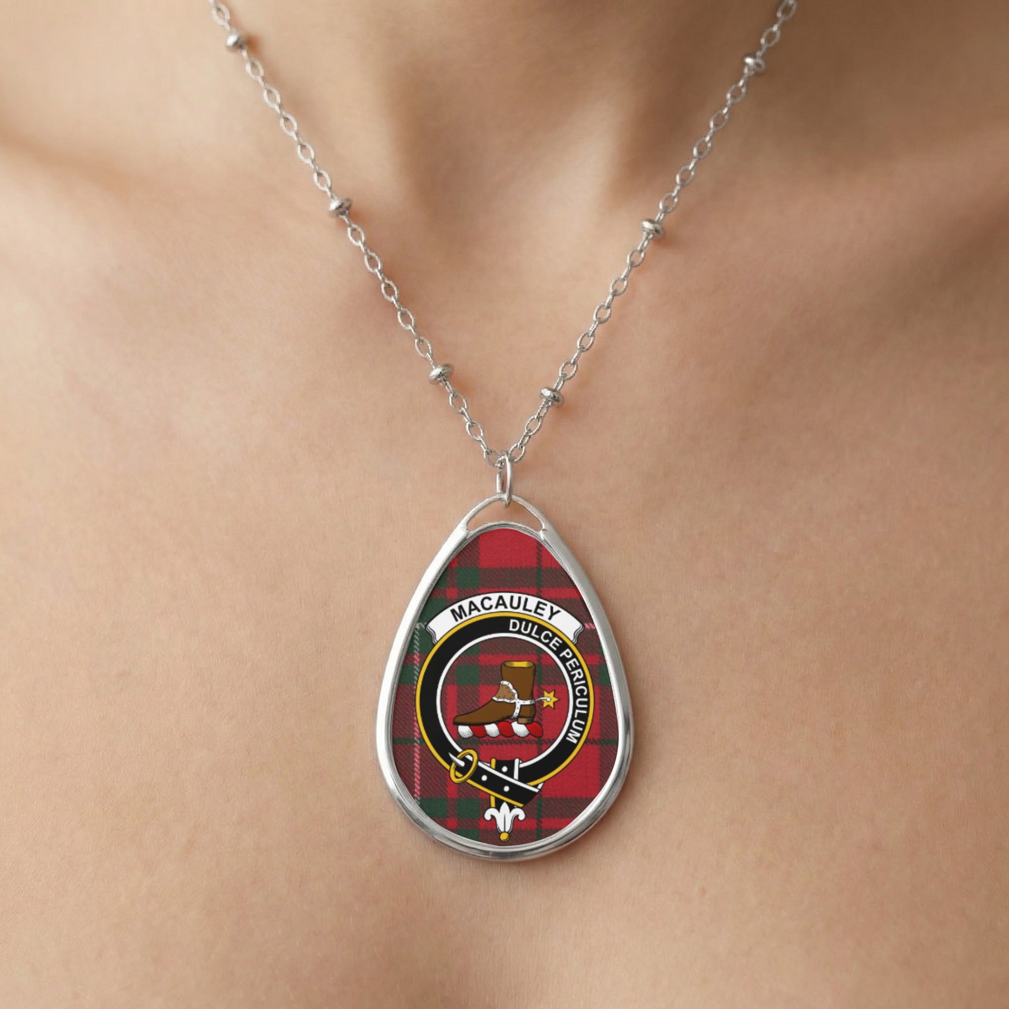 Silver necklace with oval pendant featuring Macaulay tartan and crest.