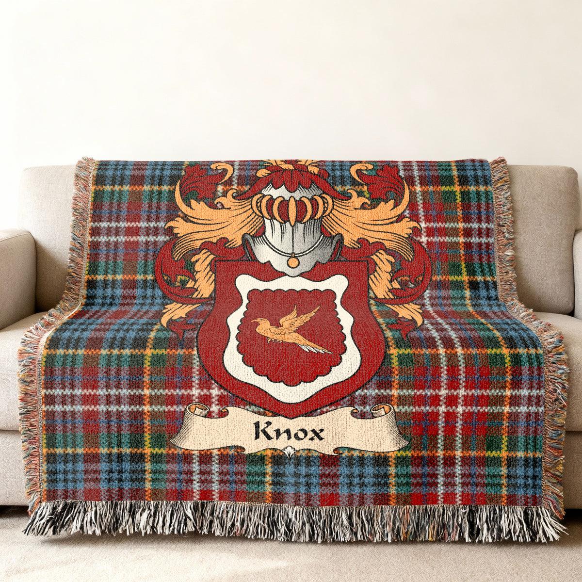 Knox family crest emblem on a Caledonia tartan woven blanket