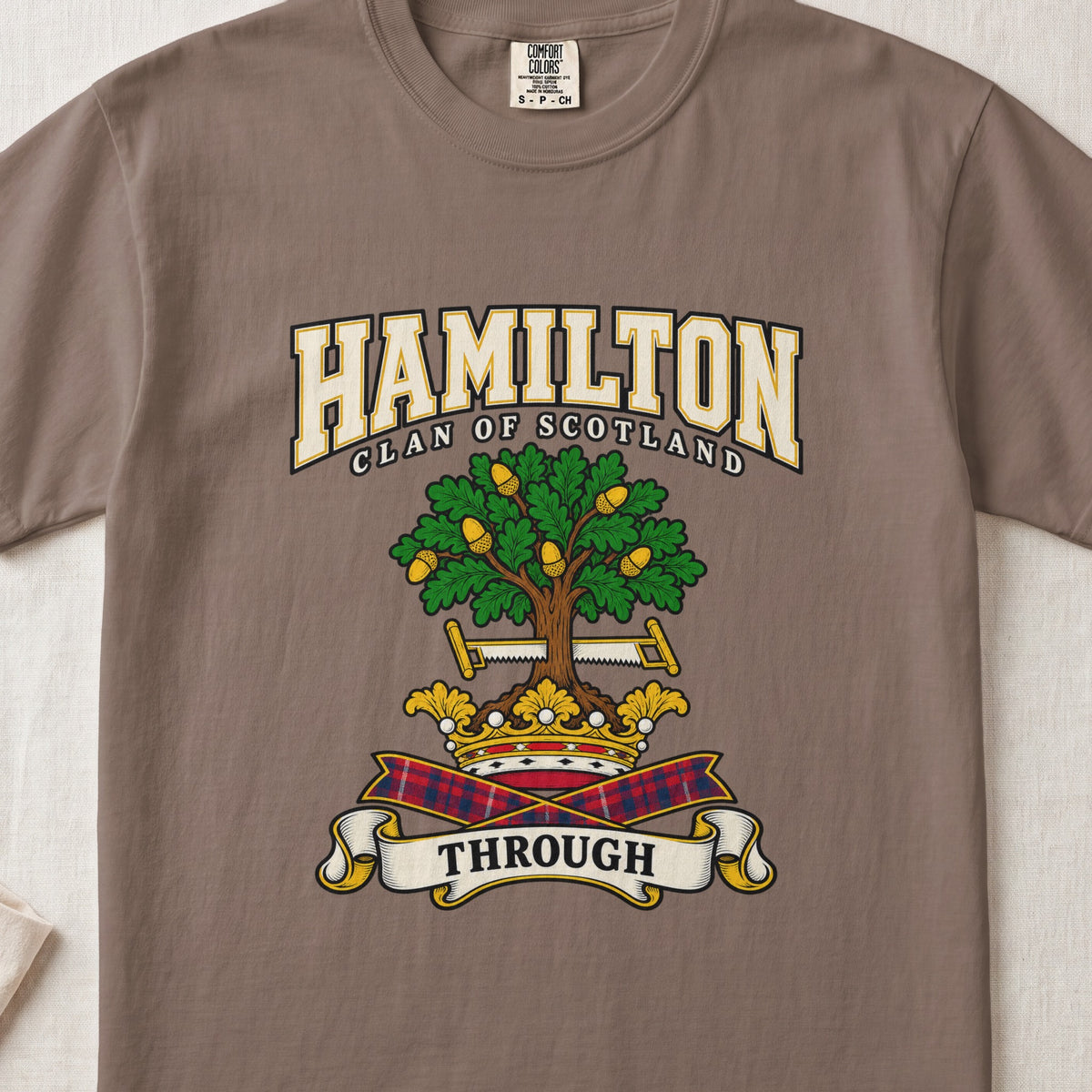 Hamilton graphic T-shirt in Espresso brown, front flat lay showing varsity lettering and green oak-like tree with gold acorns.