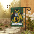 Jenkins family crest on a green plaid garden flag displayed outdoors.