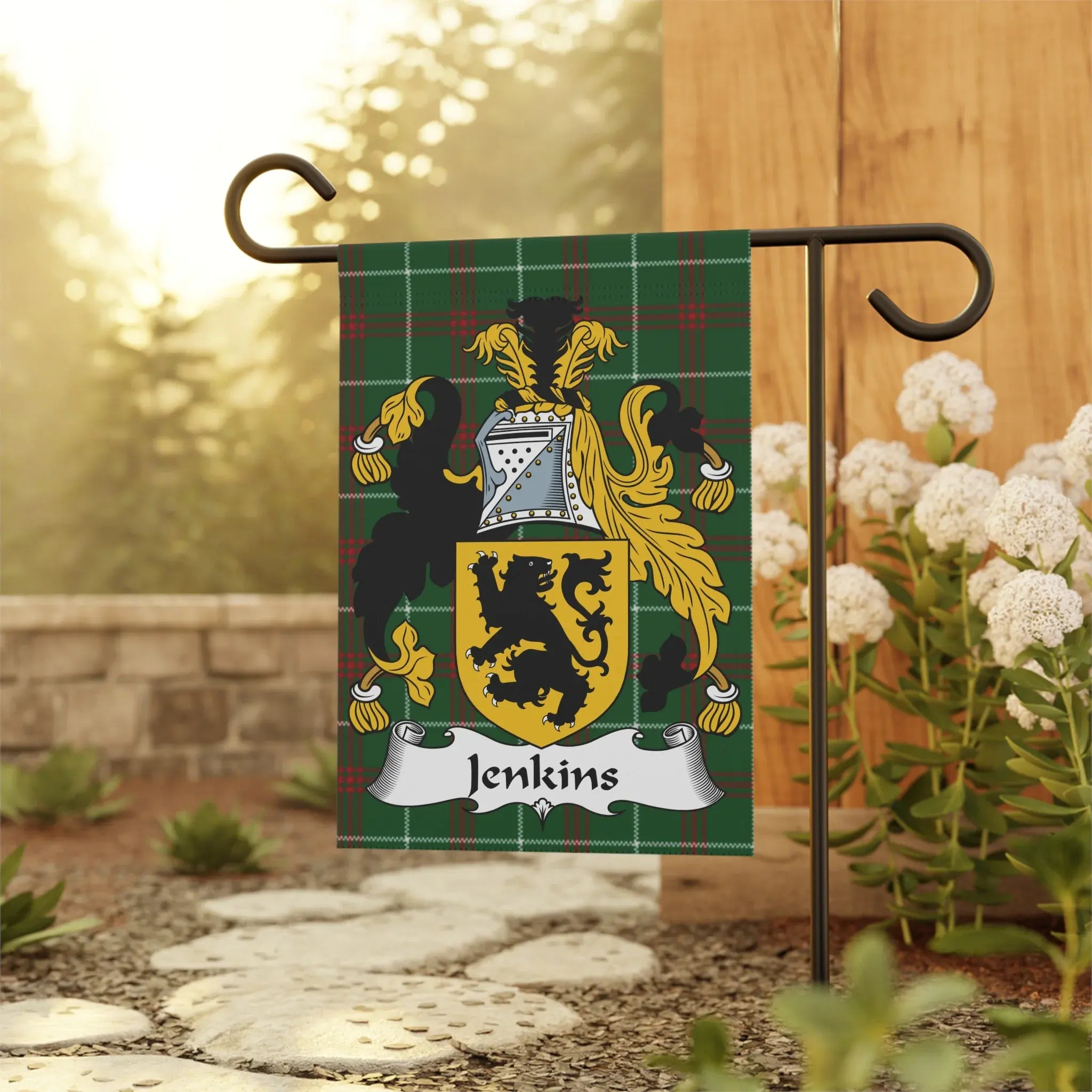 Jenkins family crest on a green plaid garden flag displayed outdoors.