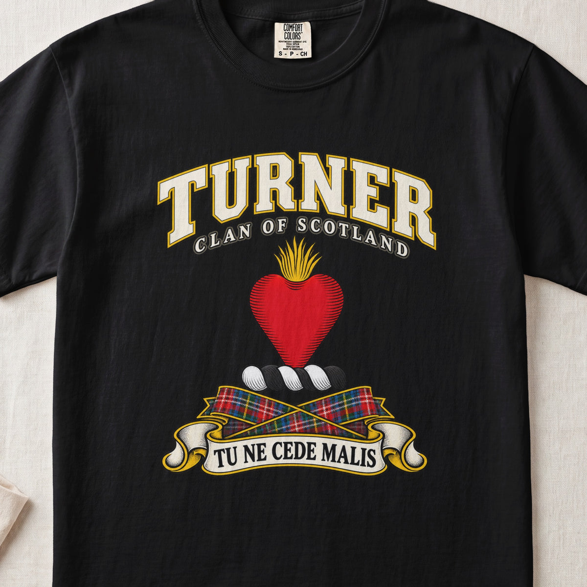 Turner Scottish clan T-shirt in Black, front view with a red heart topped with golden flames and motto banner.