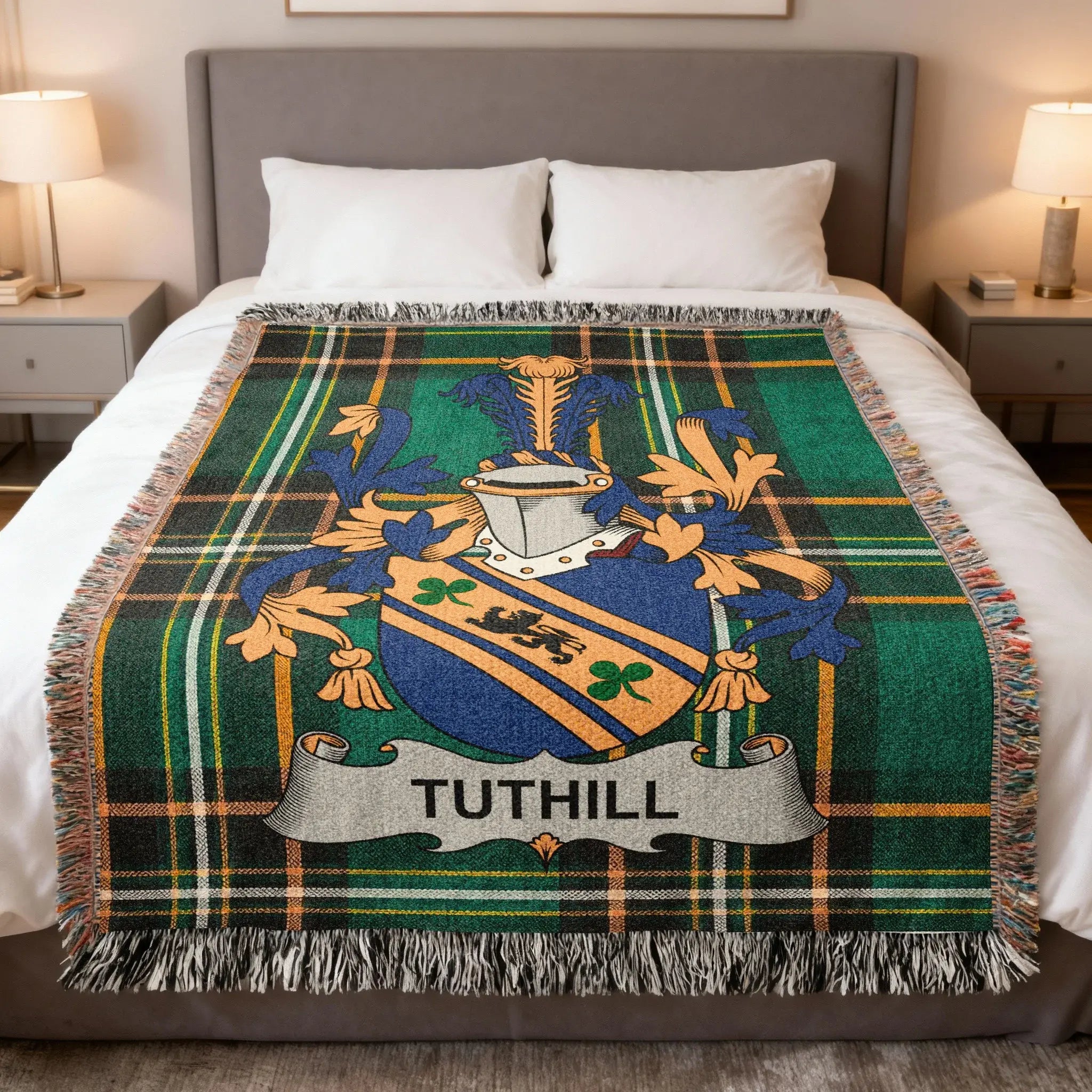 Tuthill tartan blanket with family crest draped on a bed.
