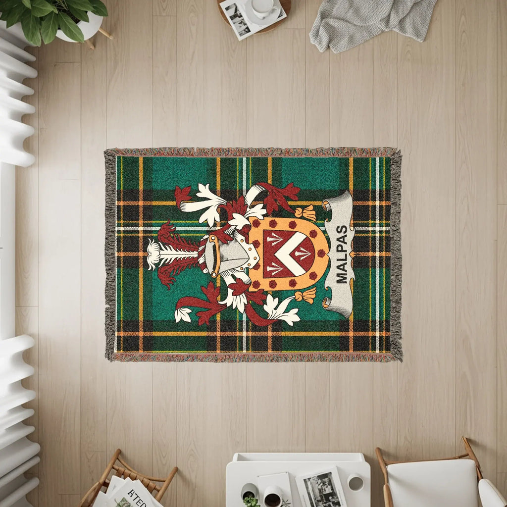 Tapestry rug with MALPAS coat of arms on green tartan background.