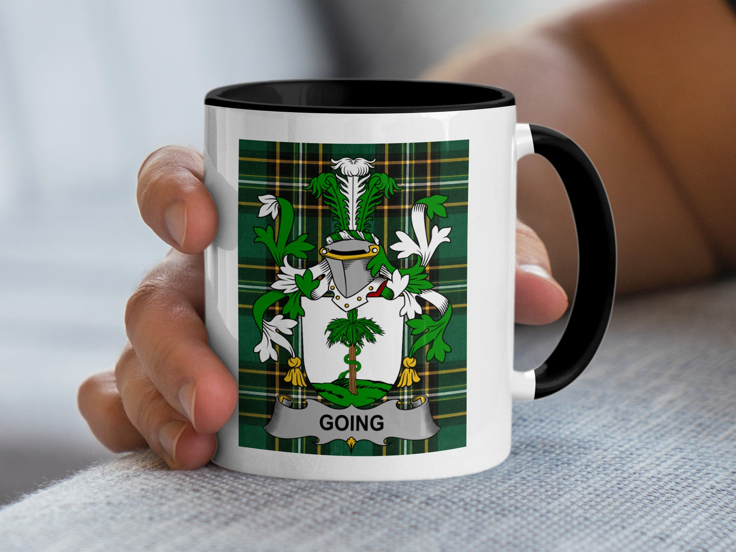 White mug with black rim, featuring a plaid crest with the name "GOING".