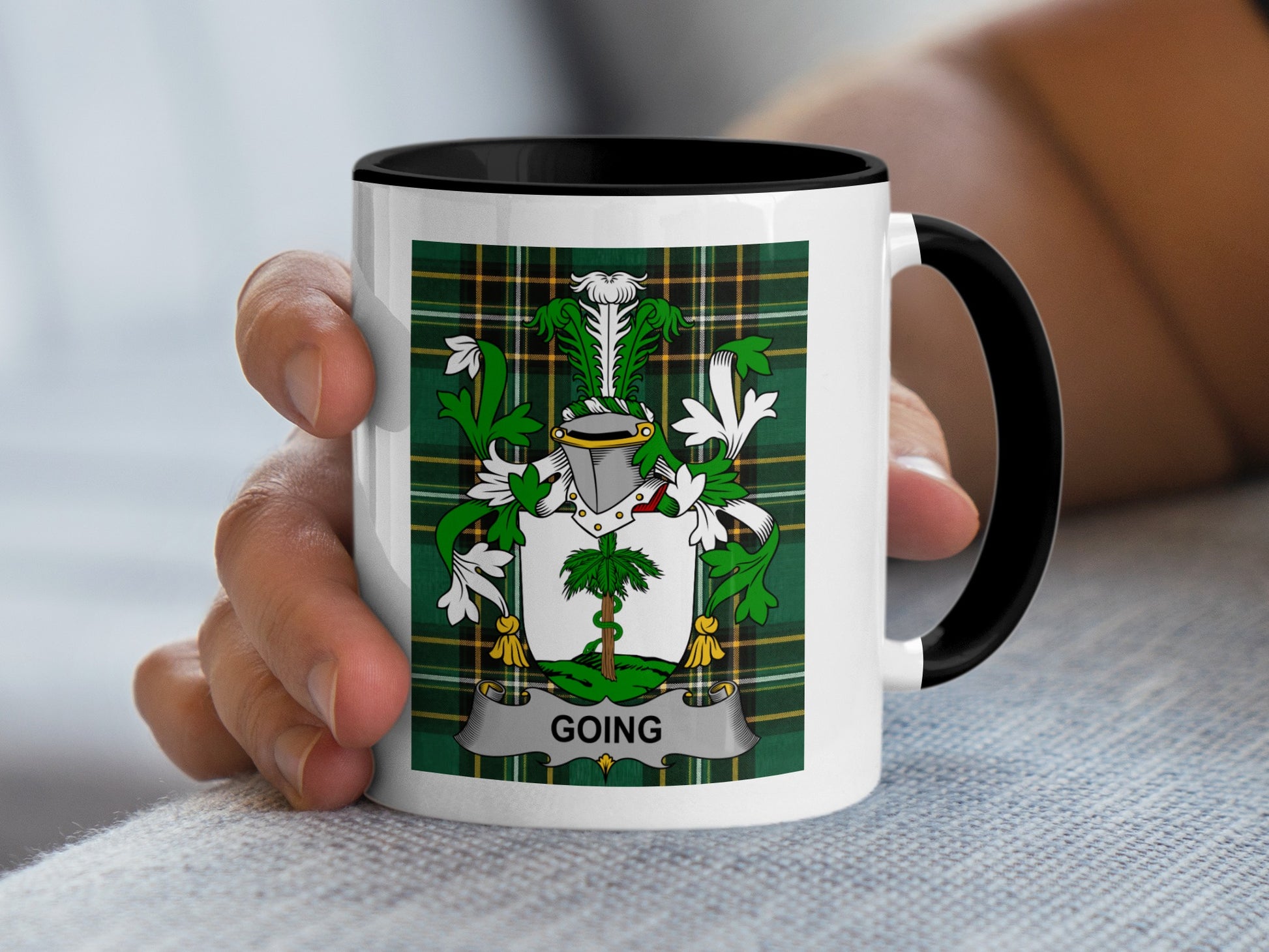 White mug with black rim, featuring a plaid crest with the name "GOING".