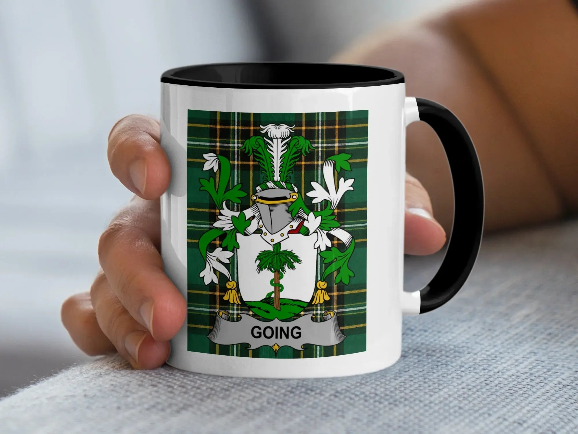 White mug with black rim, featuring a plaid crest with the name "GOING".