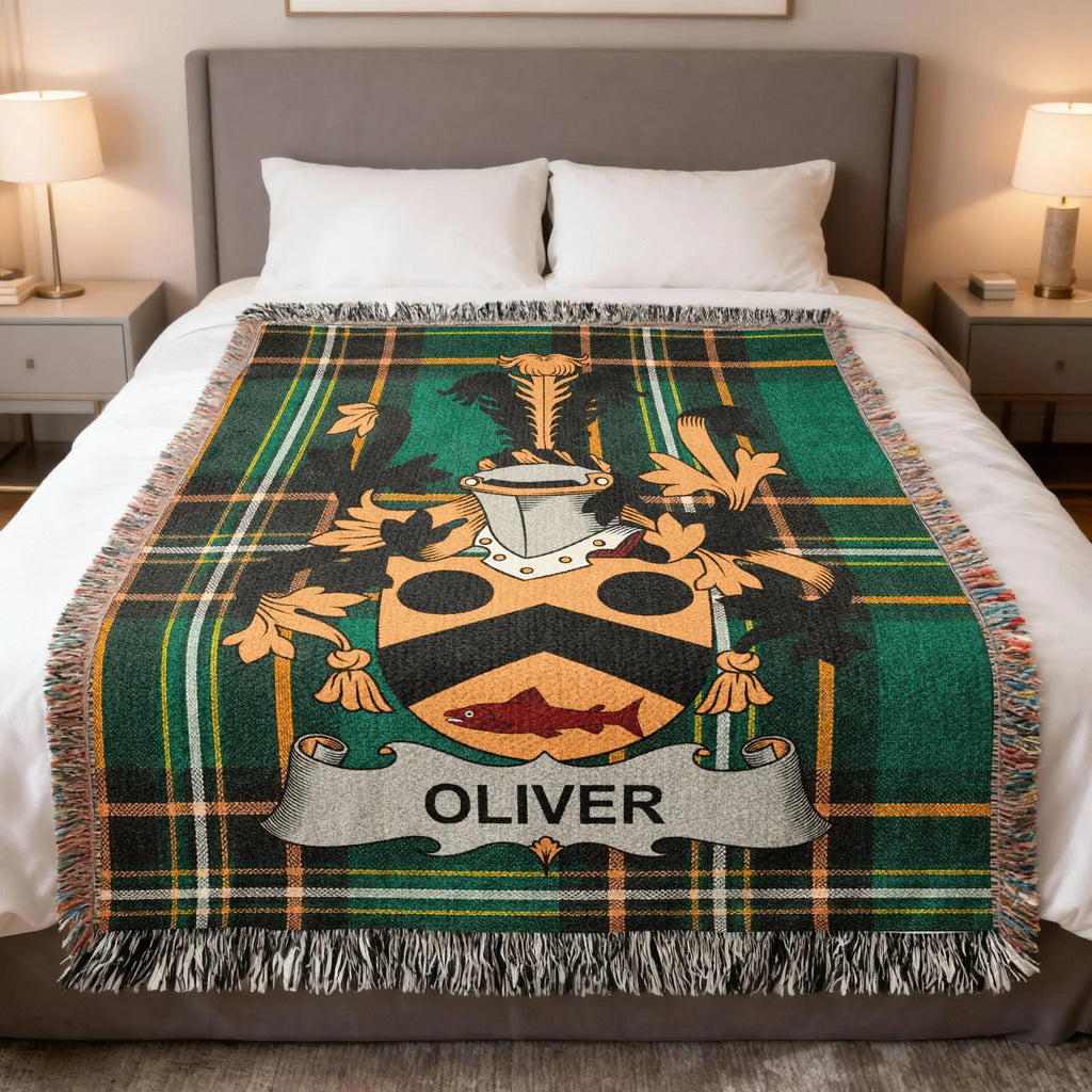 Plaid throw blanket featuring a family crest with the name "OLIVER" on a banner.