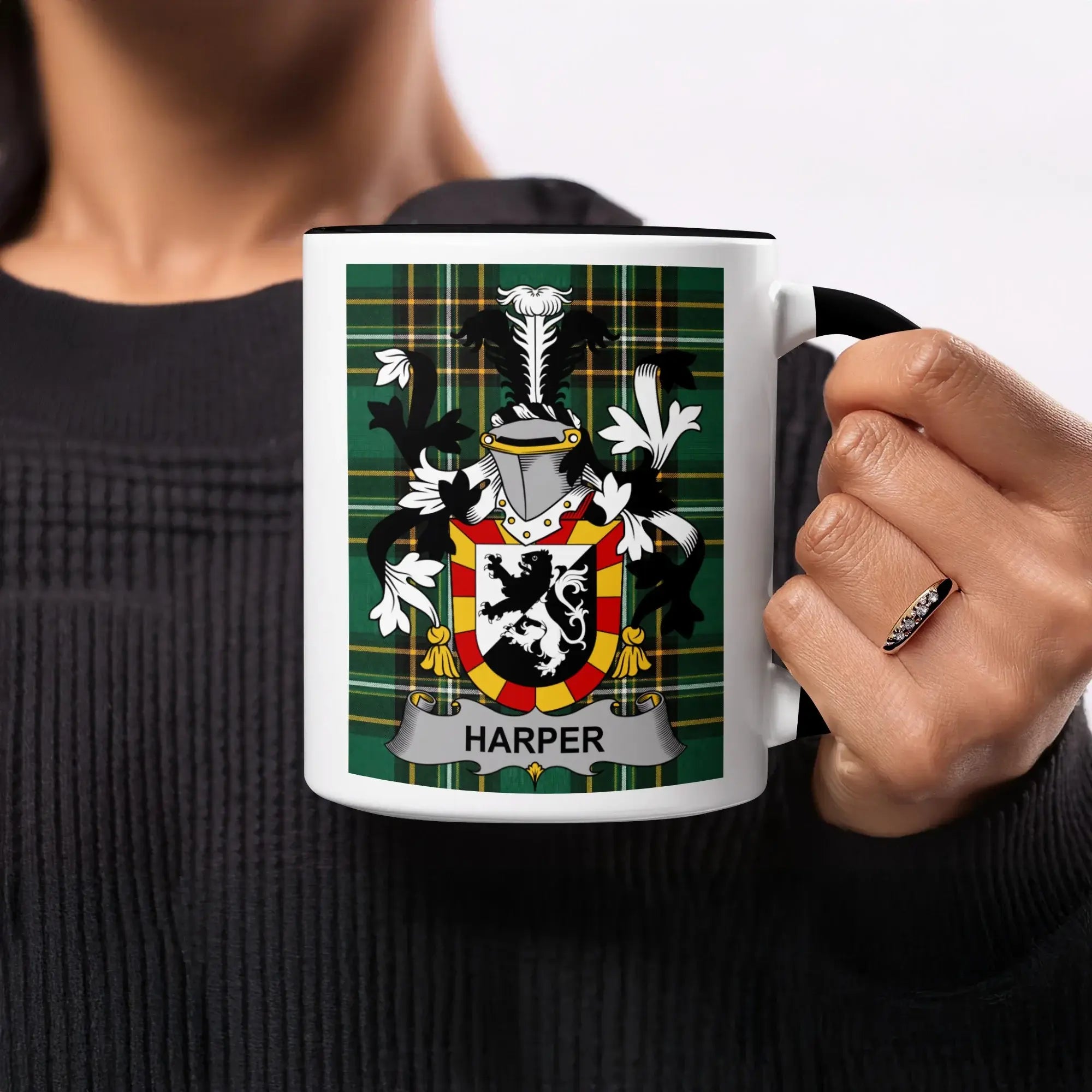 Mug with Harper family crest on green plaid background.