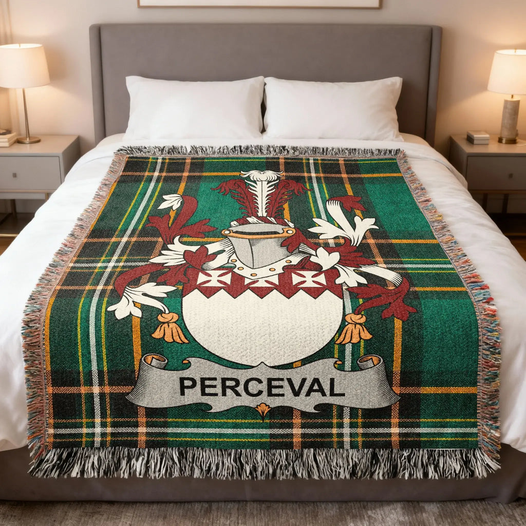 Green tartan throw blanket with a white and red family crest and "PERCEVAL" banner.
