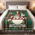 Green tartan throw blanket with a white and red family crest and "PERCEVAL" banner.