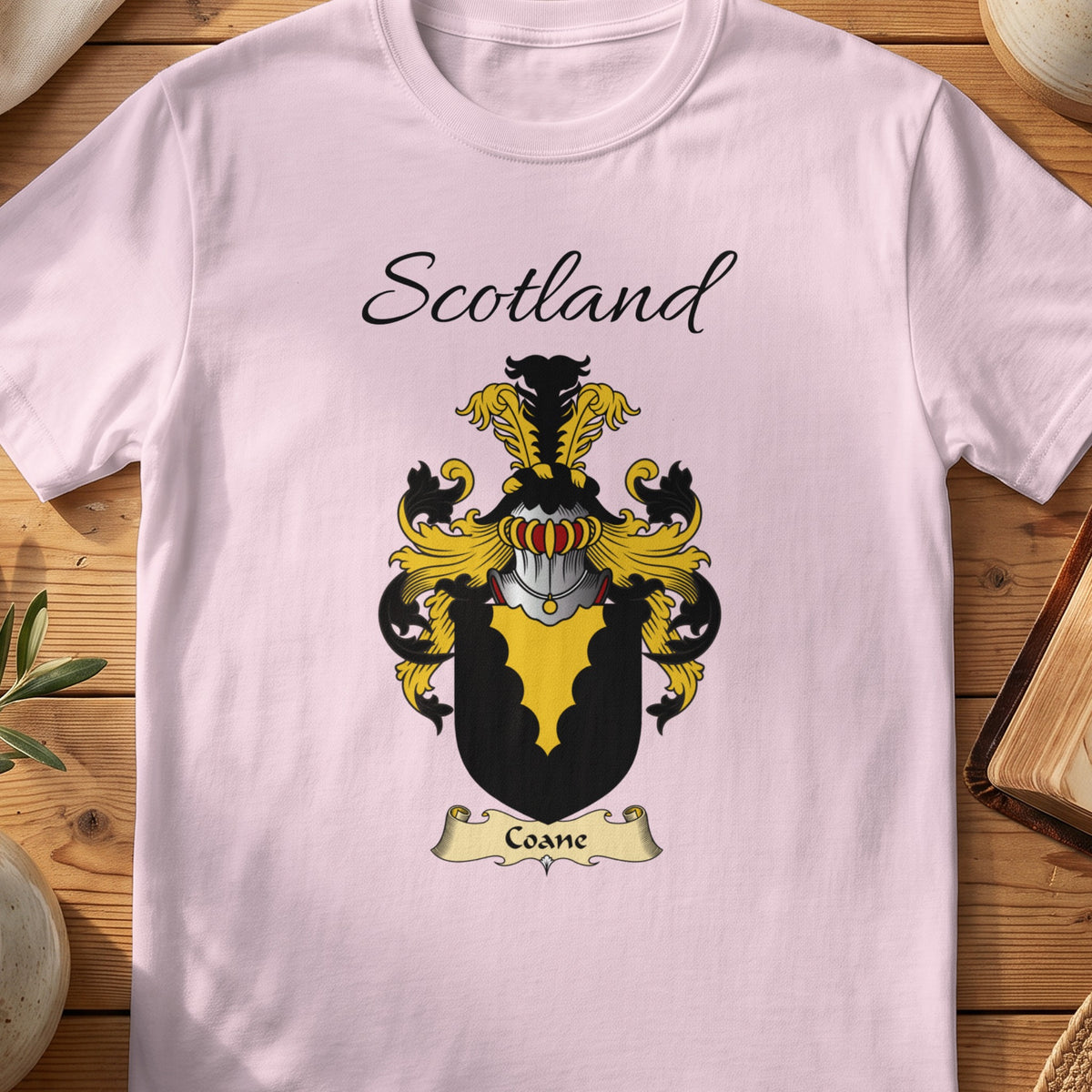 Light Pink Coane Scottish family shield T-shirt featuring a gold scalloped wedge on black