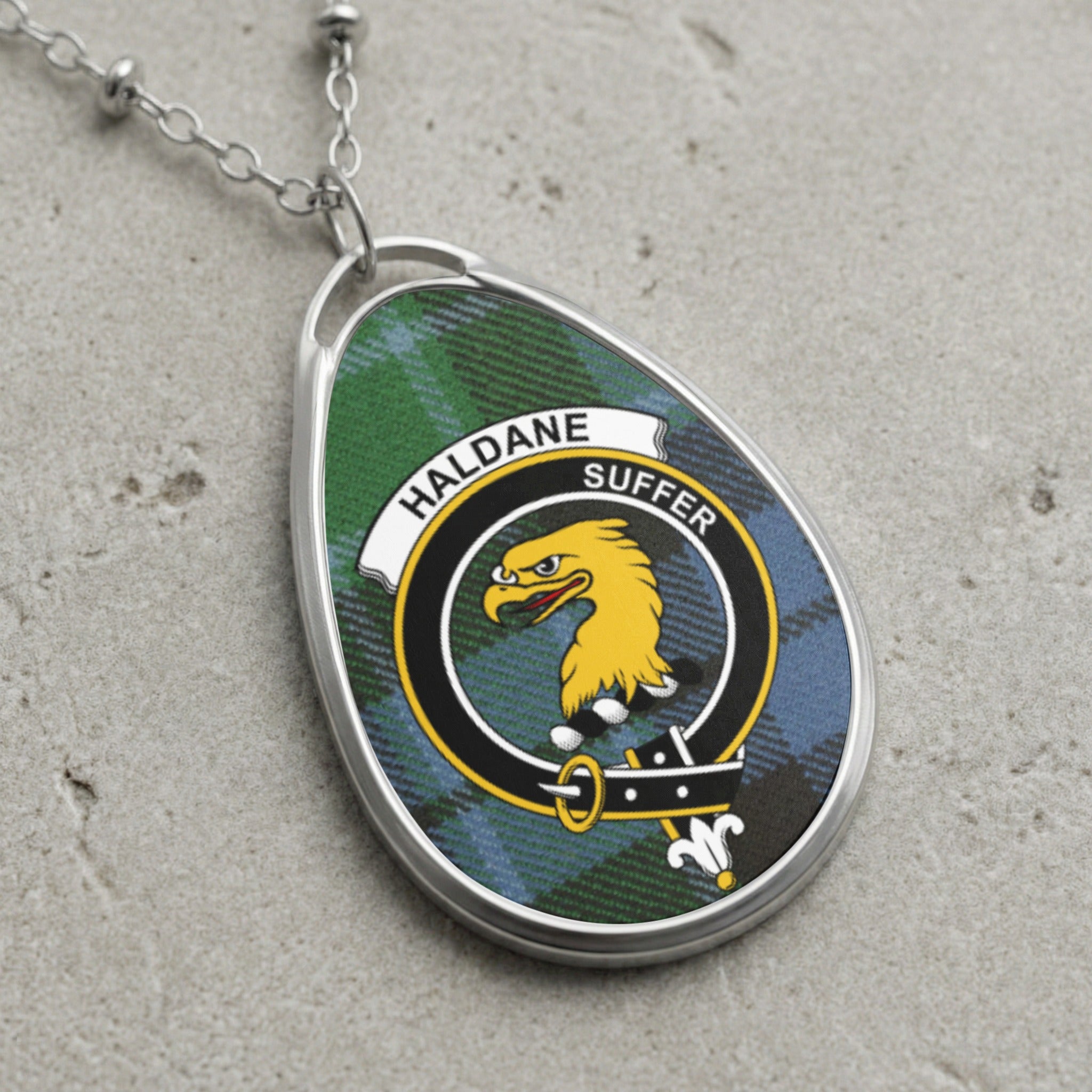 Haldane clan Scottish tartan necklace with clan crest on tartan background