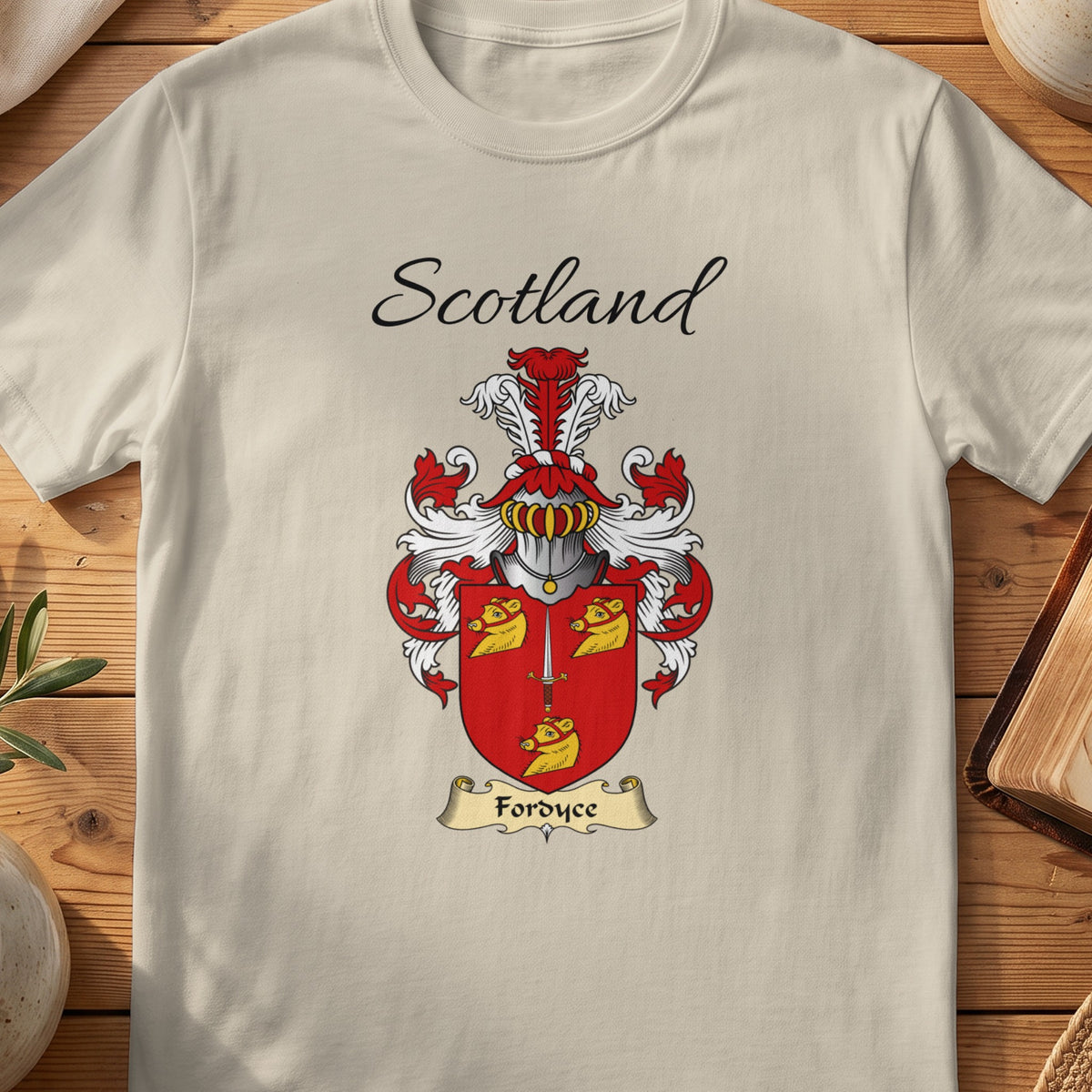 Sand Fordyce Scottish family shield T-shirt featuring gold animal heads on a red shield