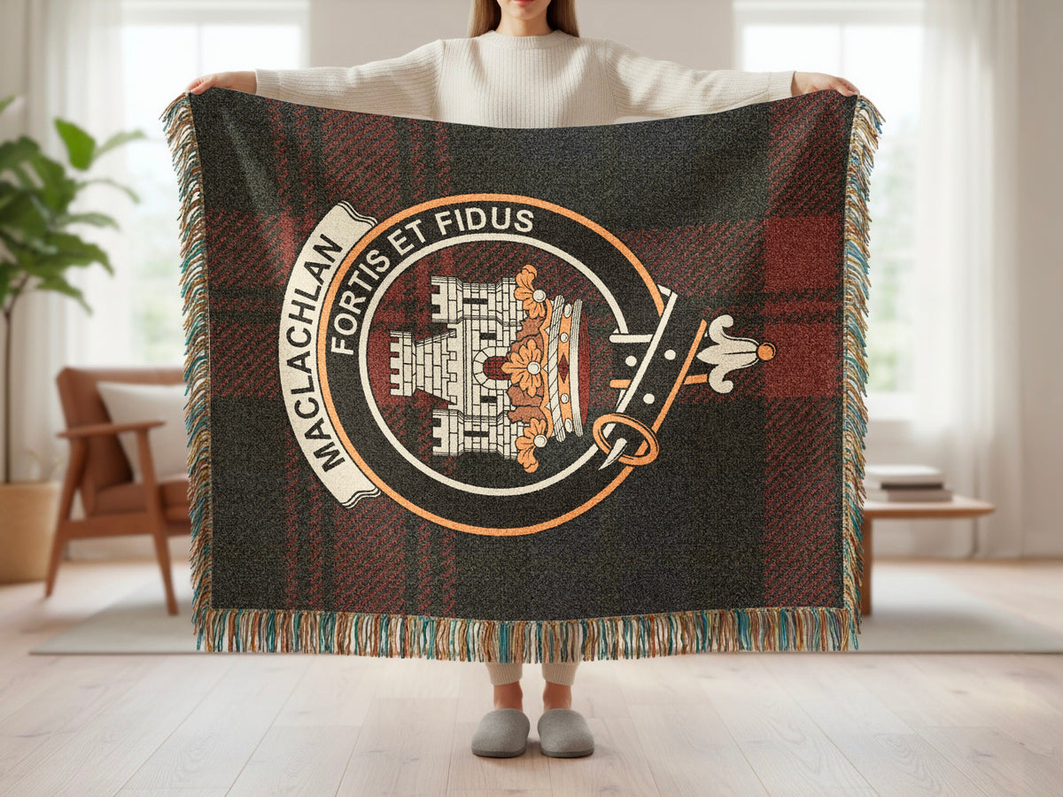 Person holding the MacLachlan woven blanket to show the full design, tartan background and fringe