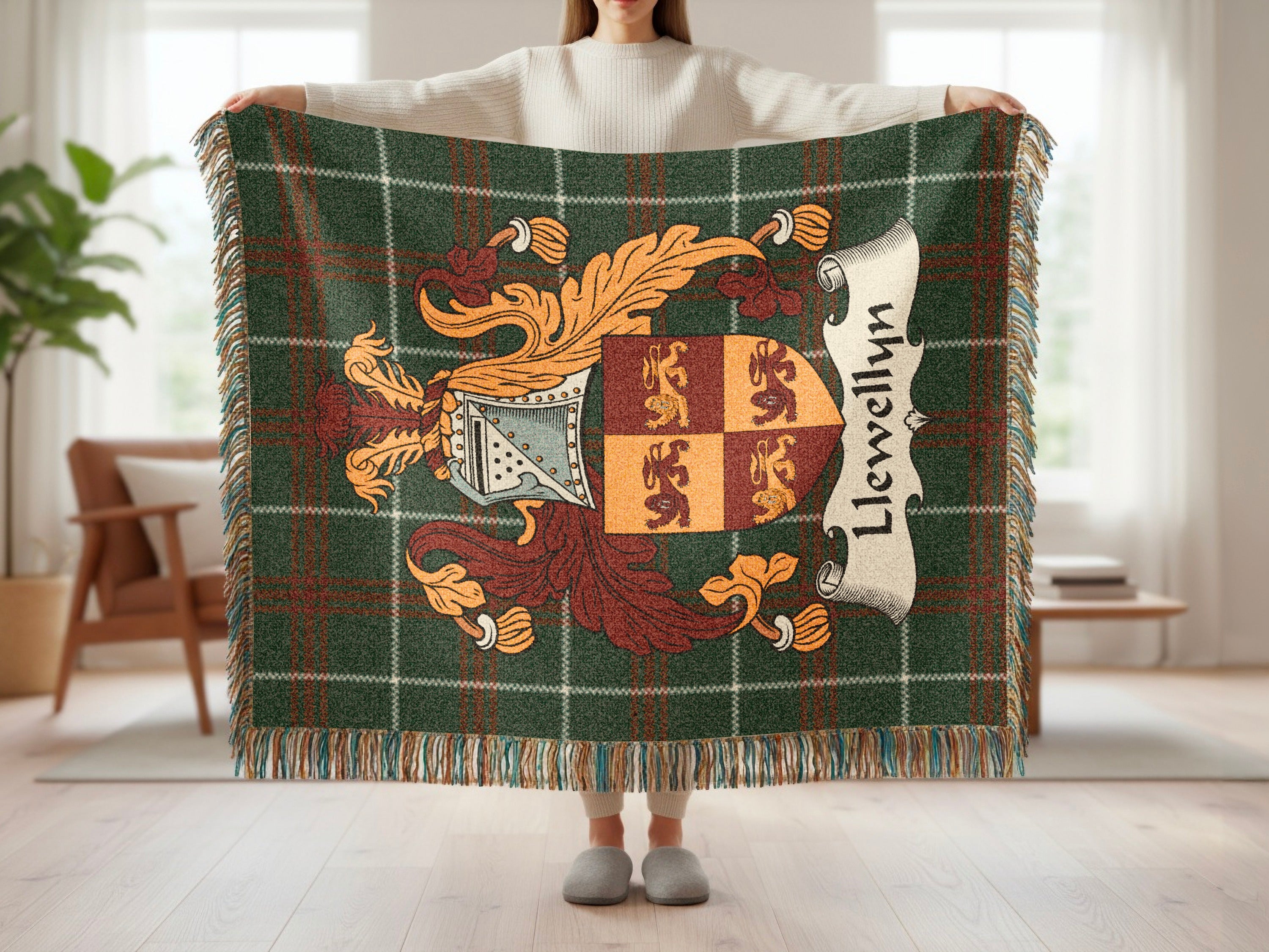 Green tartan blanket with Llewellyn family crest and fringed edges.