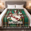 Plaid blanket with the Ring family crest displayed centrally.