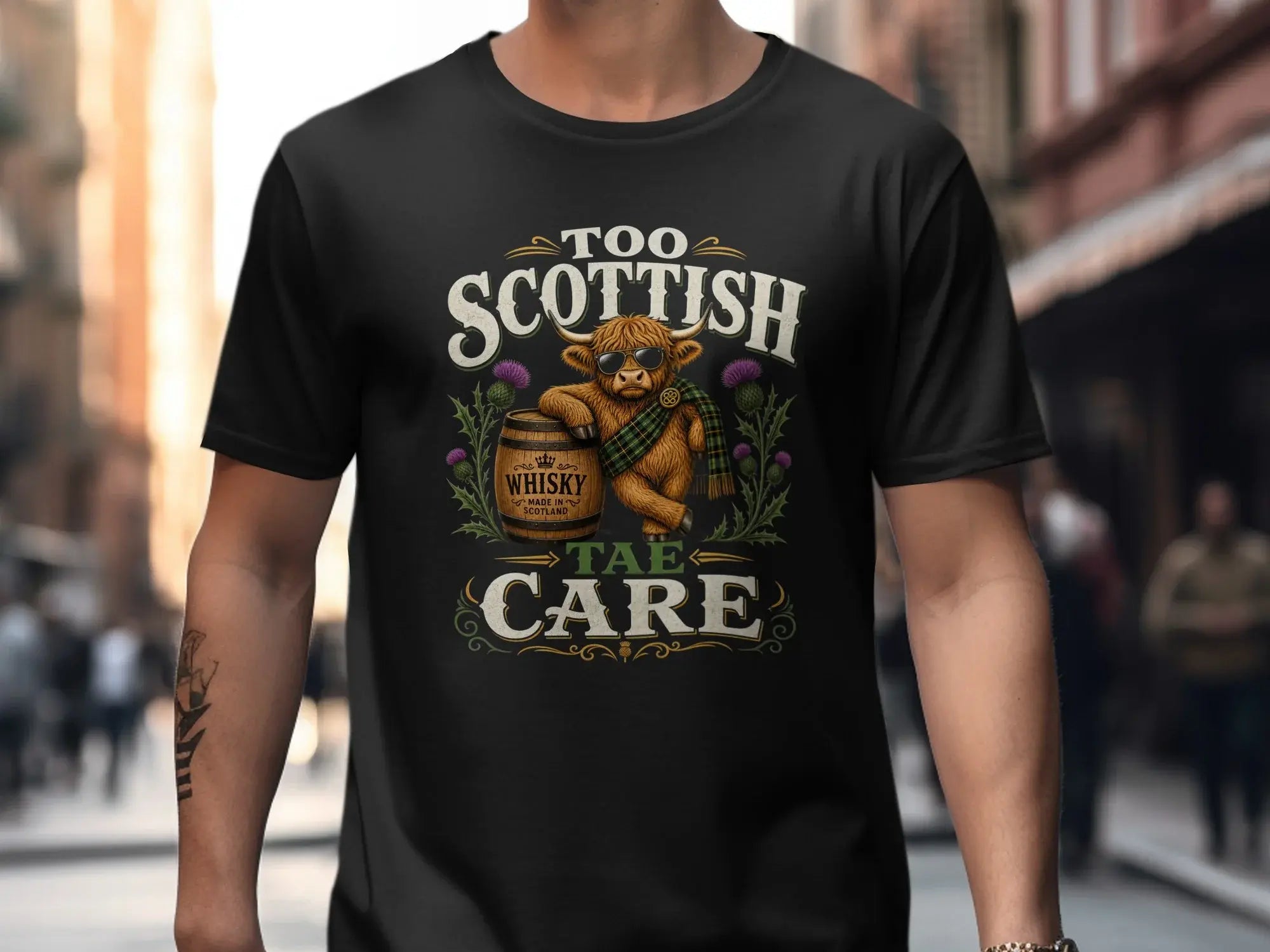 T-shirt graphic: Scottish Highland cow wearing sunglasses and kilt, "Too Taé Care" text.