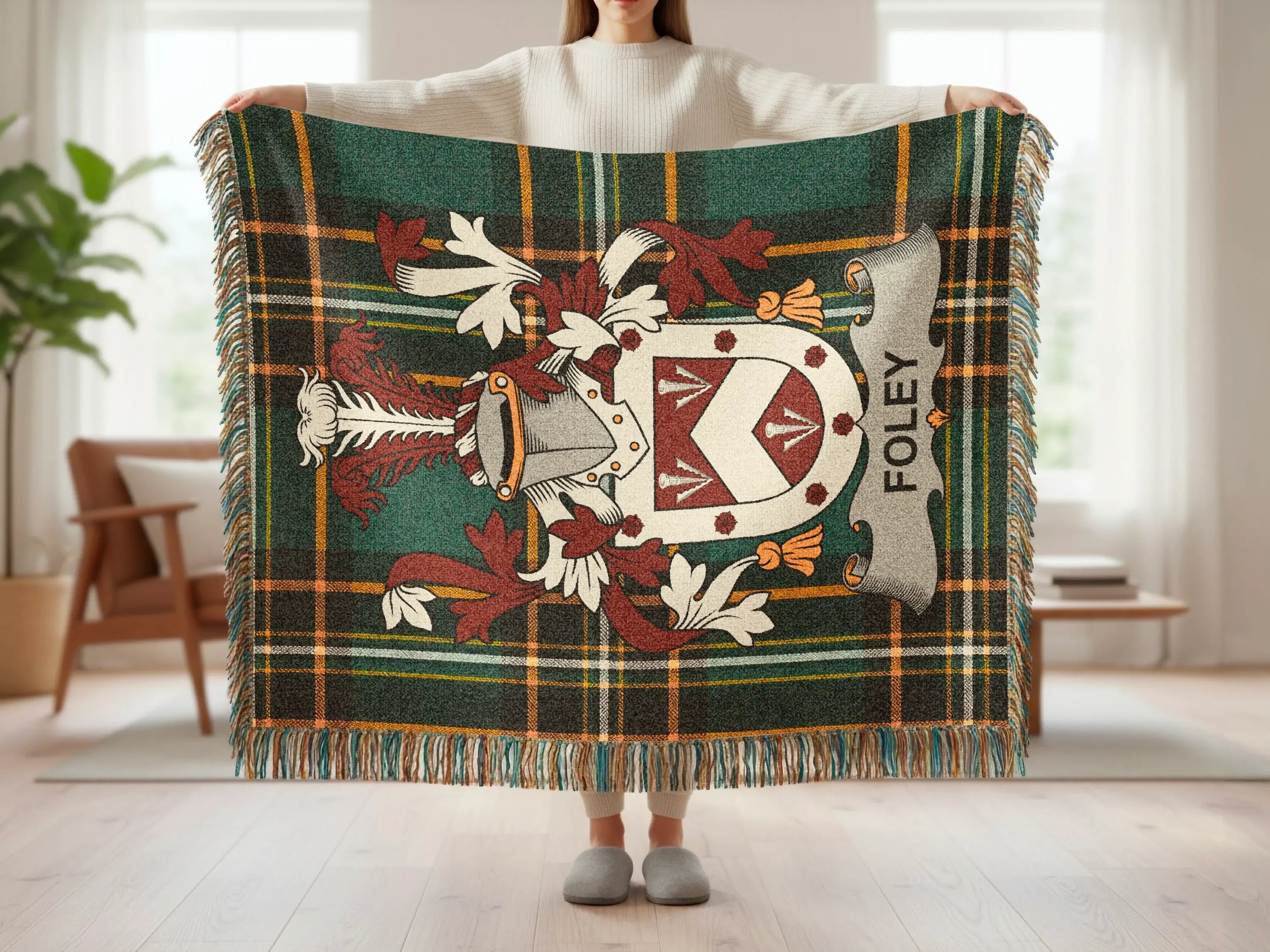 Tartan plaid throw blanket with Foley family crest in center.