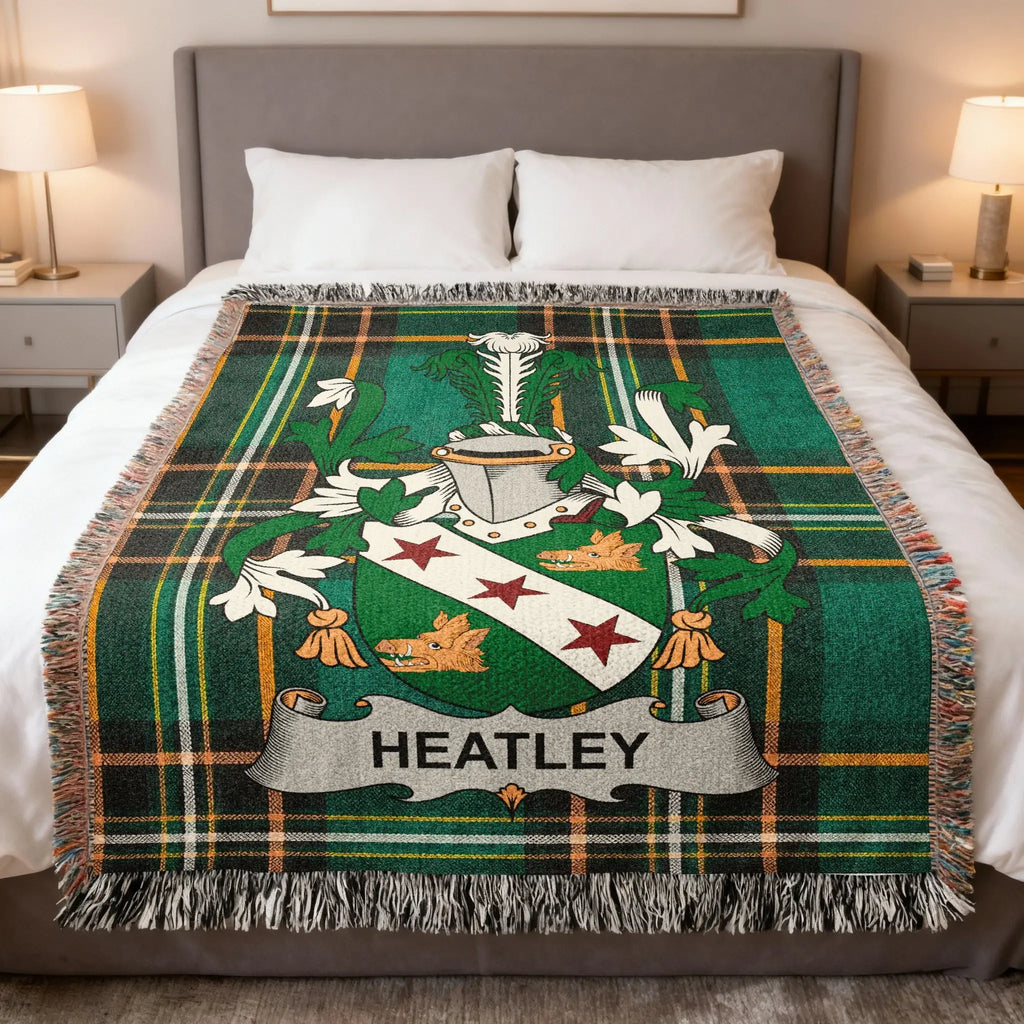 Tartan blanket with green, black, and white plaid and a crest with the name "HEATLEY".