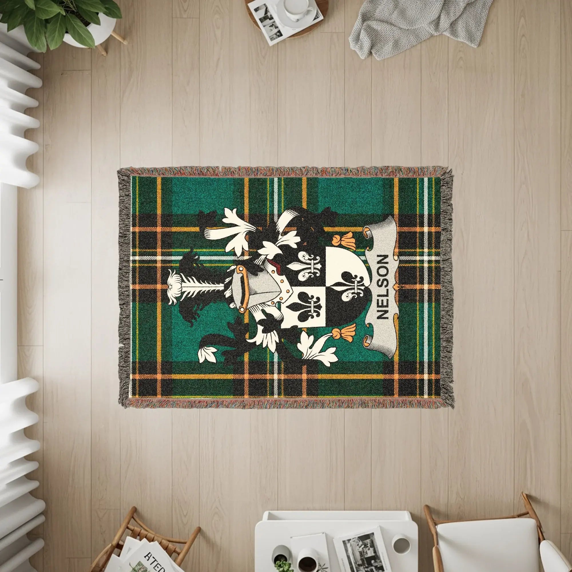 Tapestry blanket with Nelson family crest on green tartan plaid.