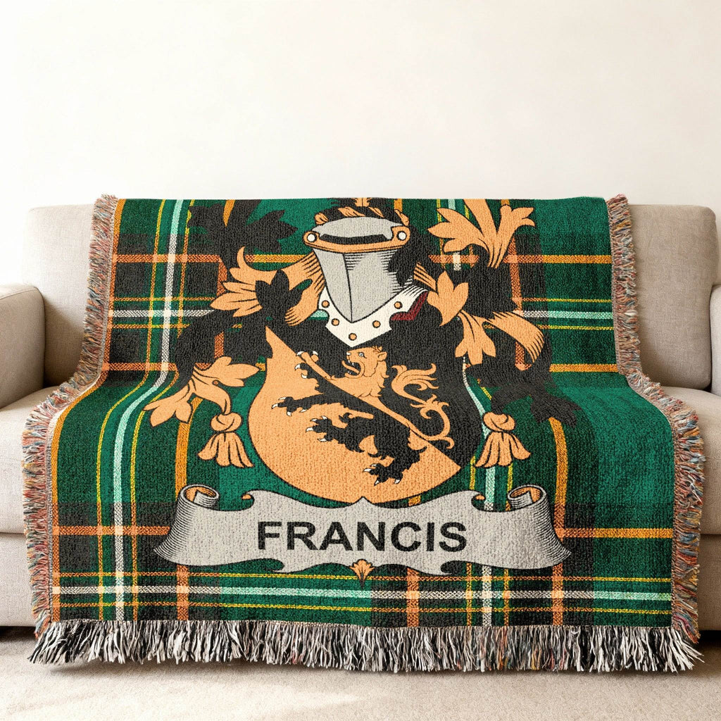 Francis family crest on a green tartan woven throw blanket draped on a sofa.