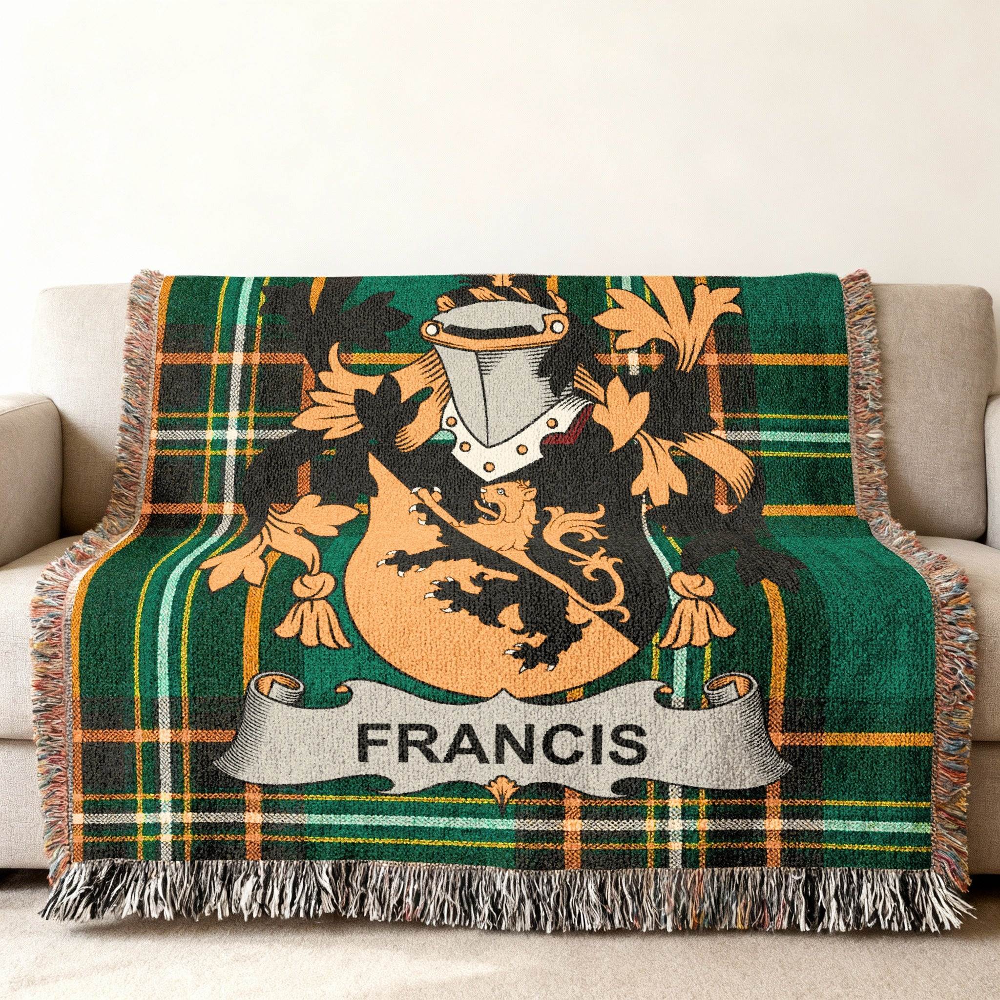 Francis family crest on a green tartan woven throw blanket draped on a sofa.