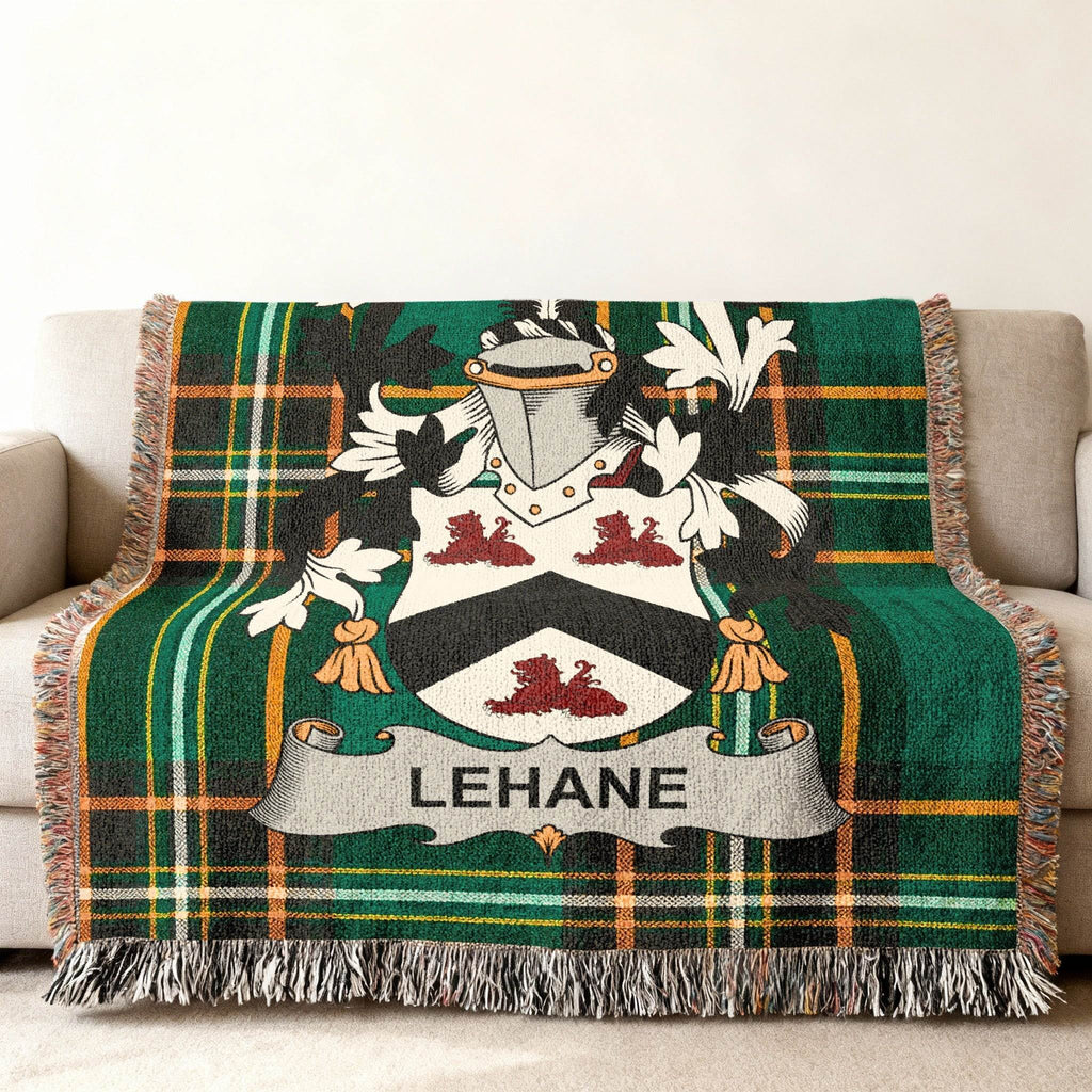 Green tartan throw blanket with LEHANE family crest centered on a couch.