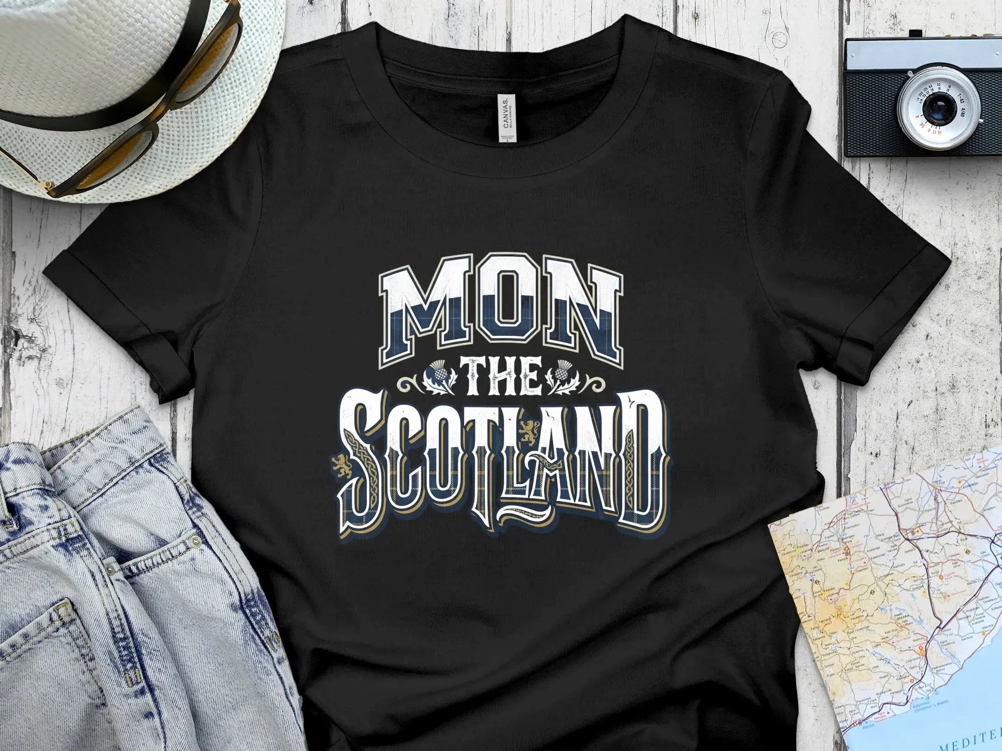 Black t-shirt with "MON SCOTLAND" text and Scottish tartan accents.