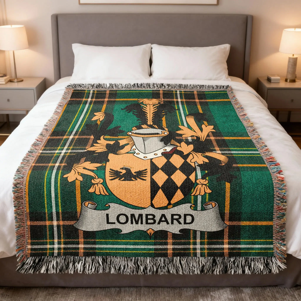 Tartan blanket with Lombard crest in green, black, and orange, on a bed.