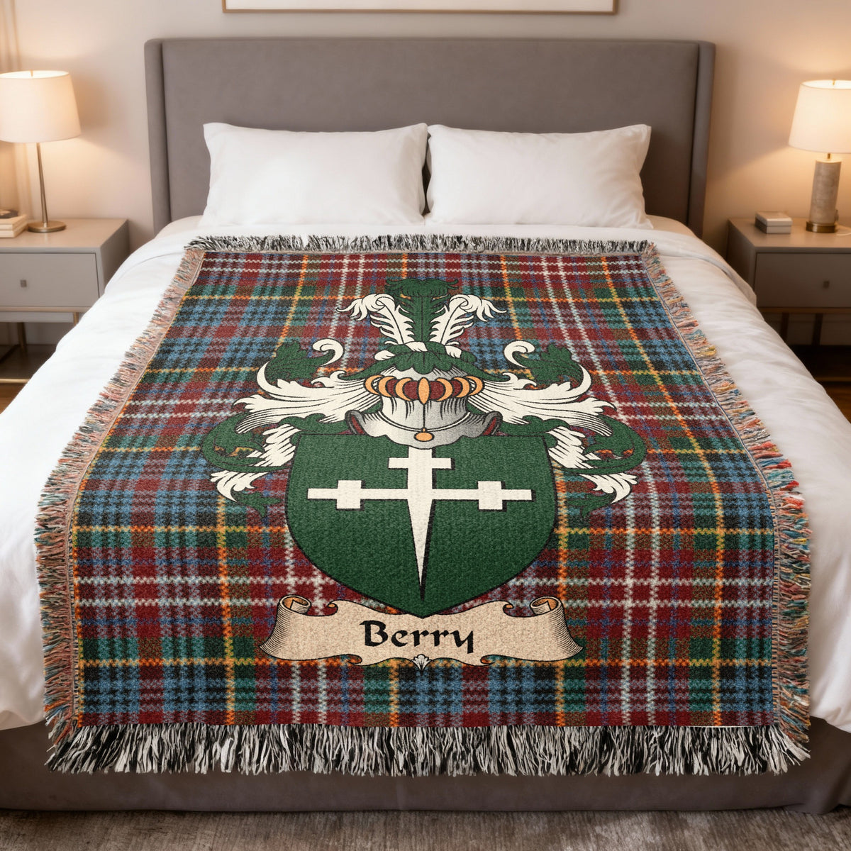 Berry Scottish family crest woven blanket on a Caledonia tartan background, displayed on a bed