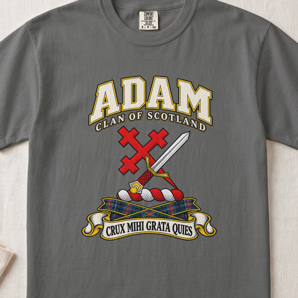 Adam Scottish clan T-shirt in Pepper, front view with a silver sword crossed with a red cross and motto banner.