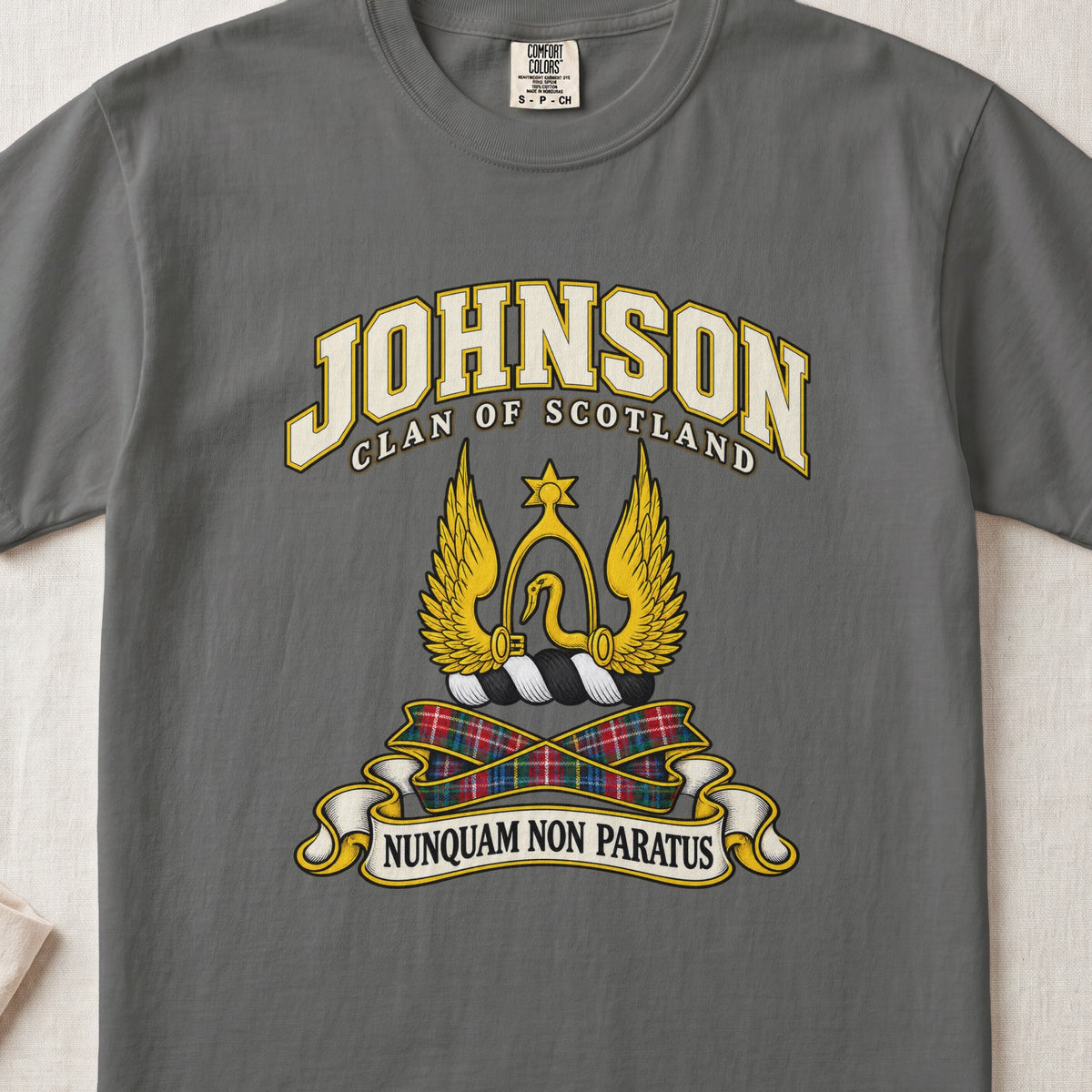 Johnson Scottish clan T-shirt in Pepper, front view with a golden winged emblem beneath a star and motto banner.