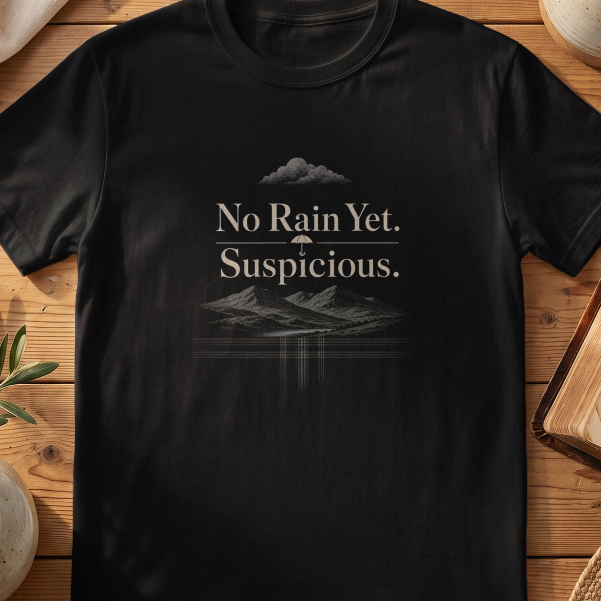 Black Gildan 64000 unisex T-shirt flatlay with No Rain Yet Suspicious Scottish graphic design
