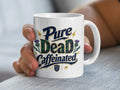 White mug with "Pure Caffeinated" text in blue and green plaid.