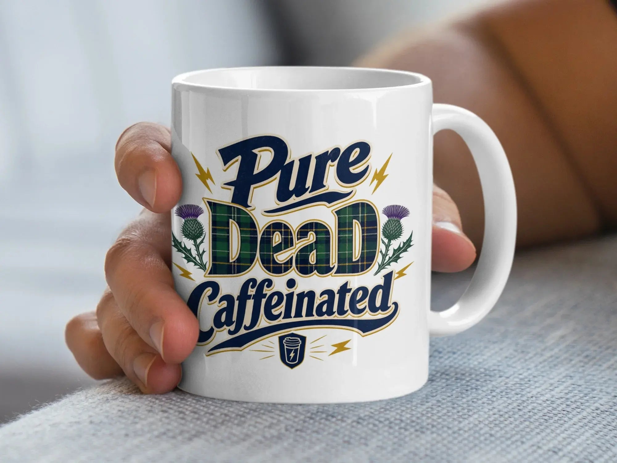 White mug with "Pure Caffeinated" text in blue and green plaid.
