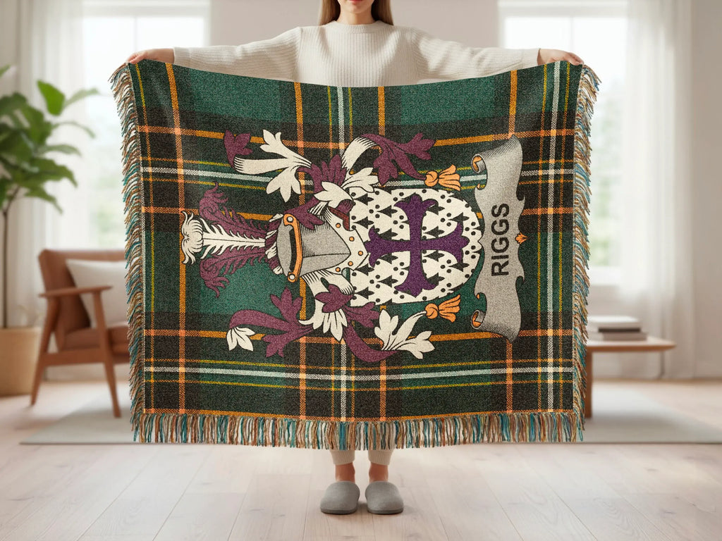 Tartan blanket with "RIGGS" banner and heraldic crest, held by a person.