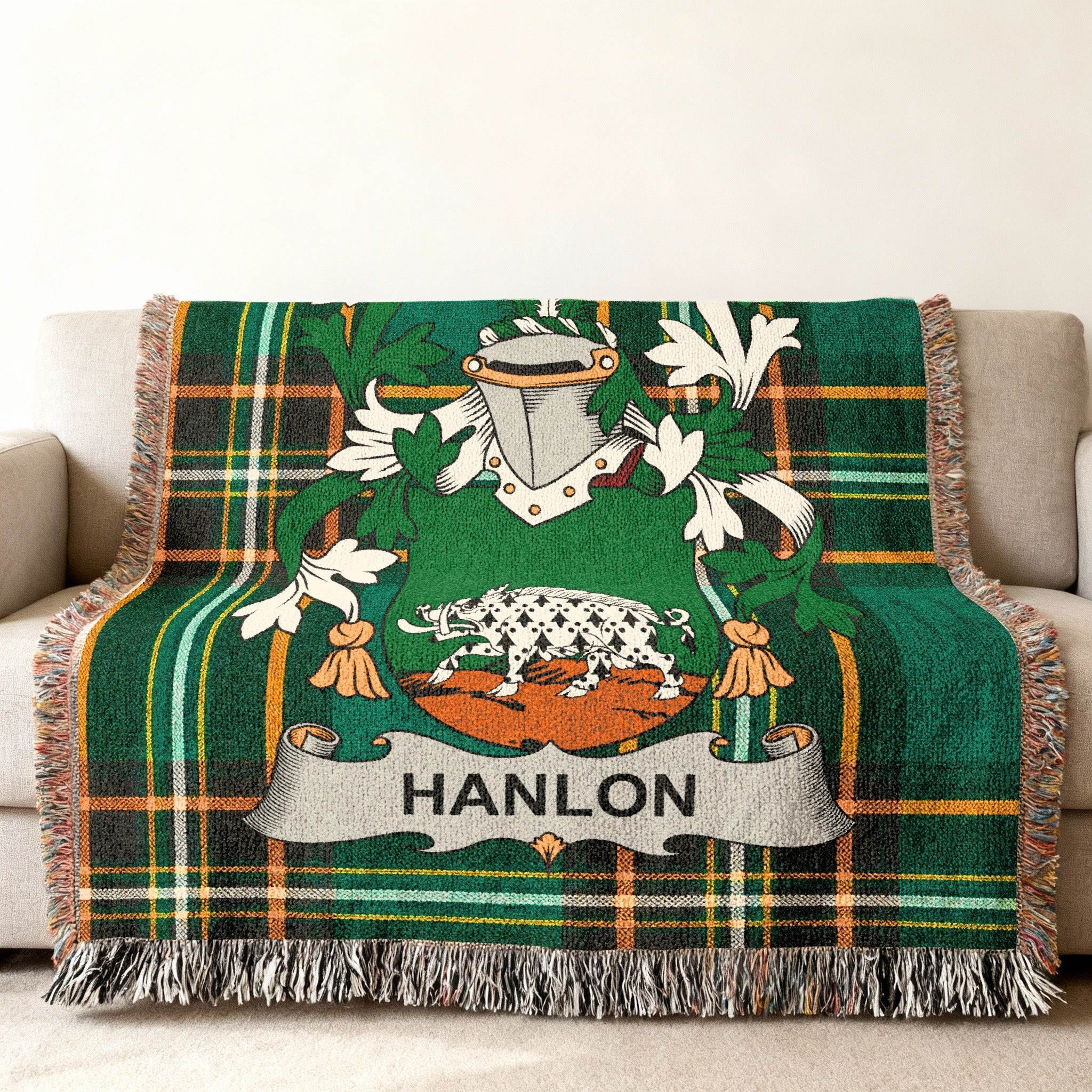 Green plaid throw blanket featuring the Hanlon family crest with a boar.
