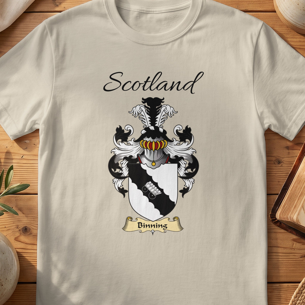 Sand Binning Scottish family shield T-shirt featuring a pale linked-hands motif on a black diagonal band