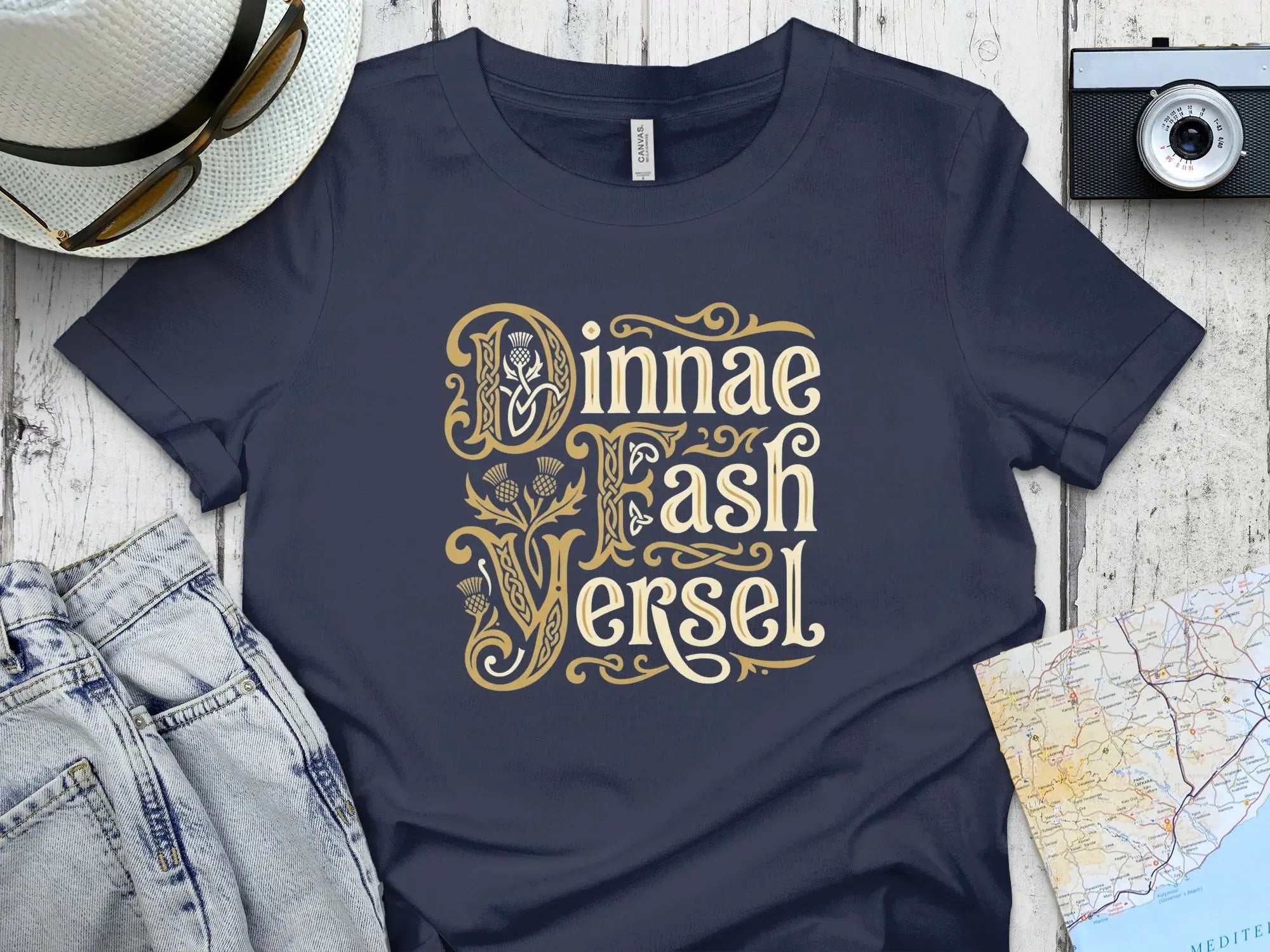Navy t-shirt with gold text "Jinnae Fash Versel" and Celtic knot designs.