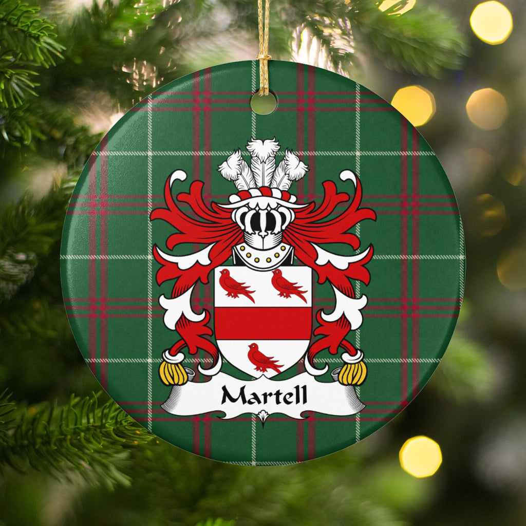 Martell ornament hanging among Christmas tree branches and warm lights, with a red horizontal band and three red birds on a white shield on Welsh National Tartan.