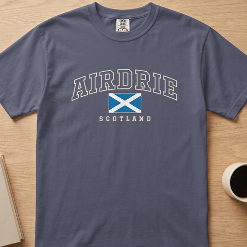 Denim Comfort Colors T-shirt laid flat with Airdrie, Scotland lettering and a blue-and-white Saltire
