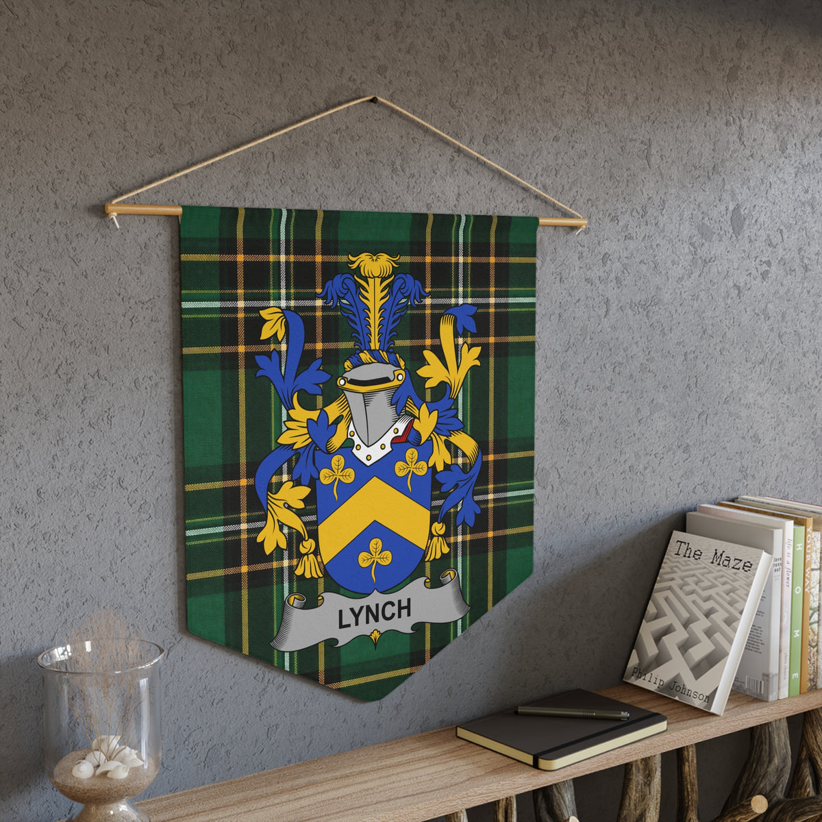 Tartan pennant with Lynch family crest, hanging on a textured wall.