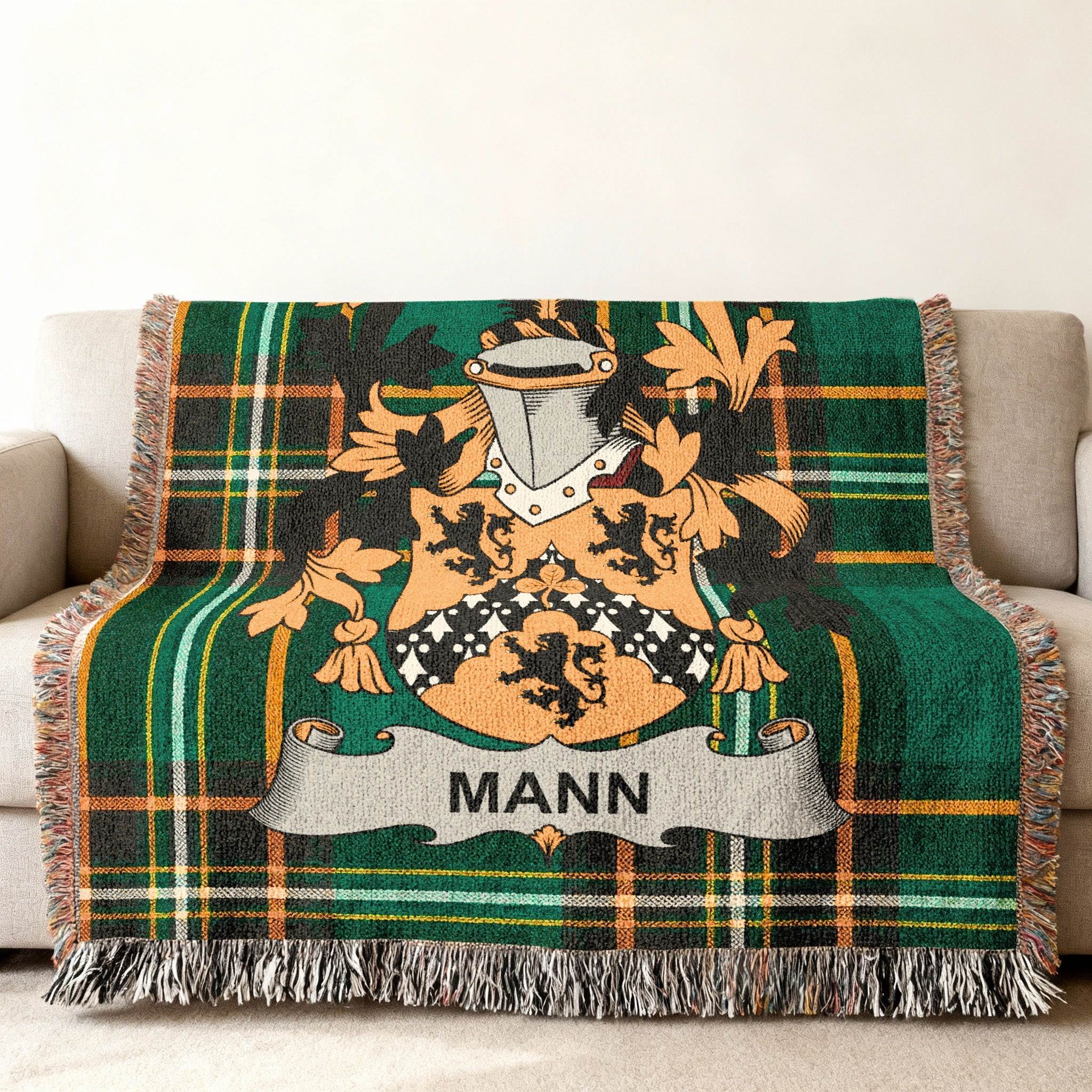 Green tartan blanket with a family crest and "MANN" banner.